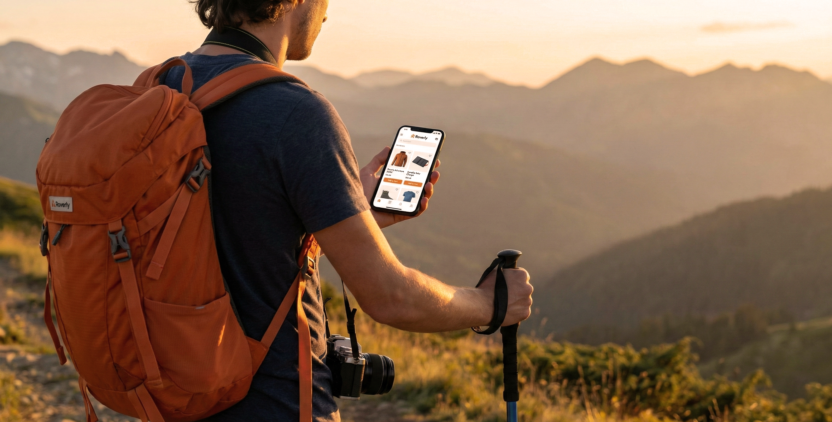 Hiker with orange backpack and camera holding a trekking pole and checking a hiking app on a smartphone with mountain scenery at sunset.