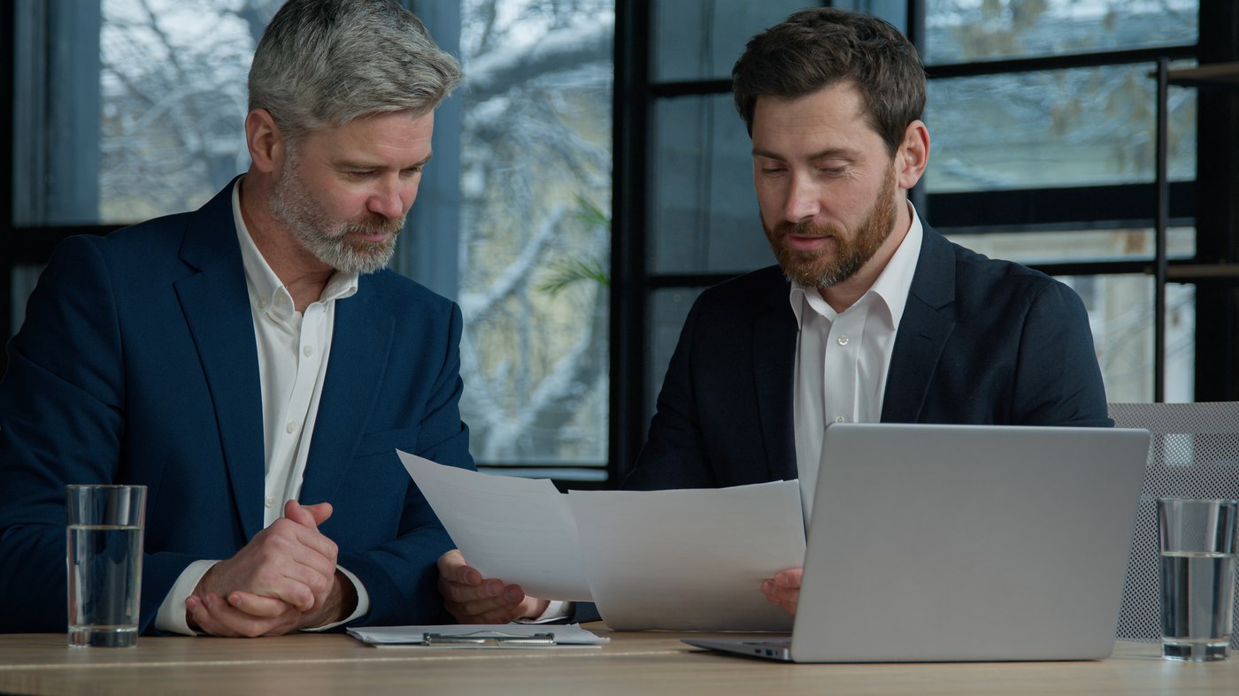 Two people reviewing a vendor contract together