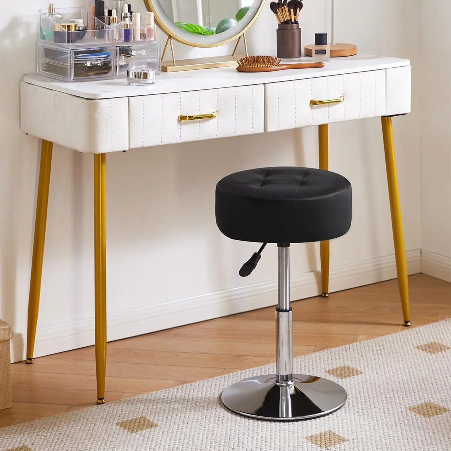 Black adjustable swivel vanity stool in front of a makeup vanity table