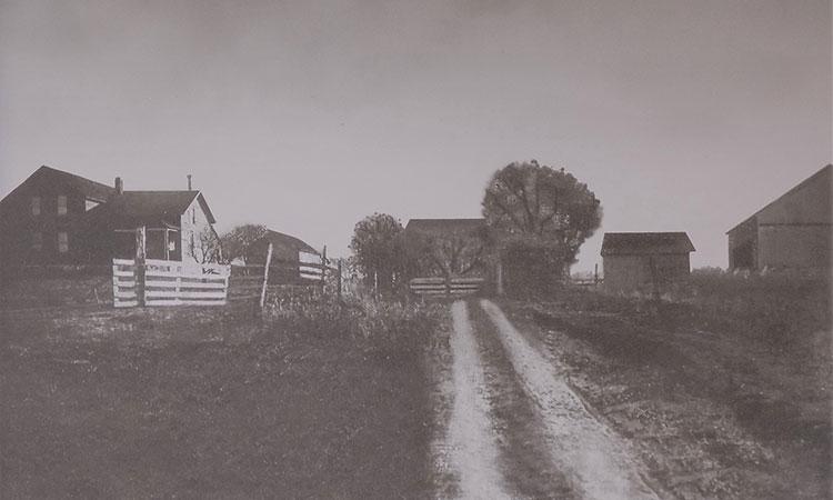 old black and white photo of a home and land