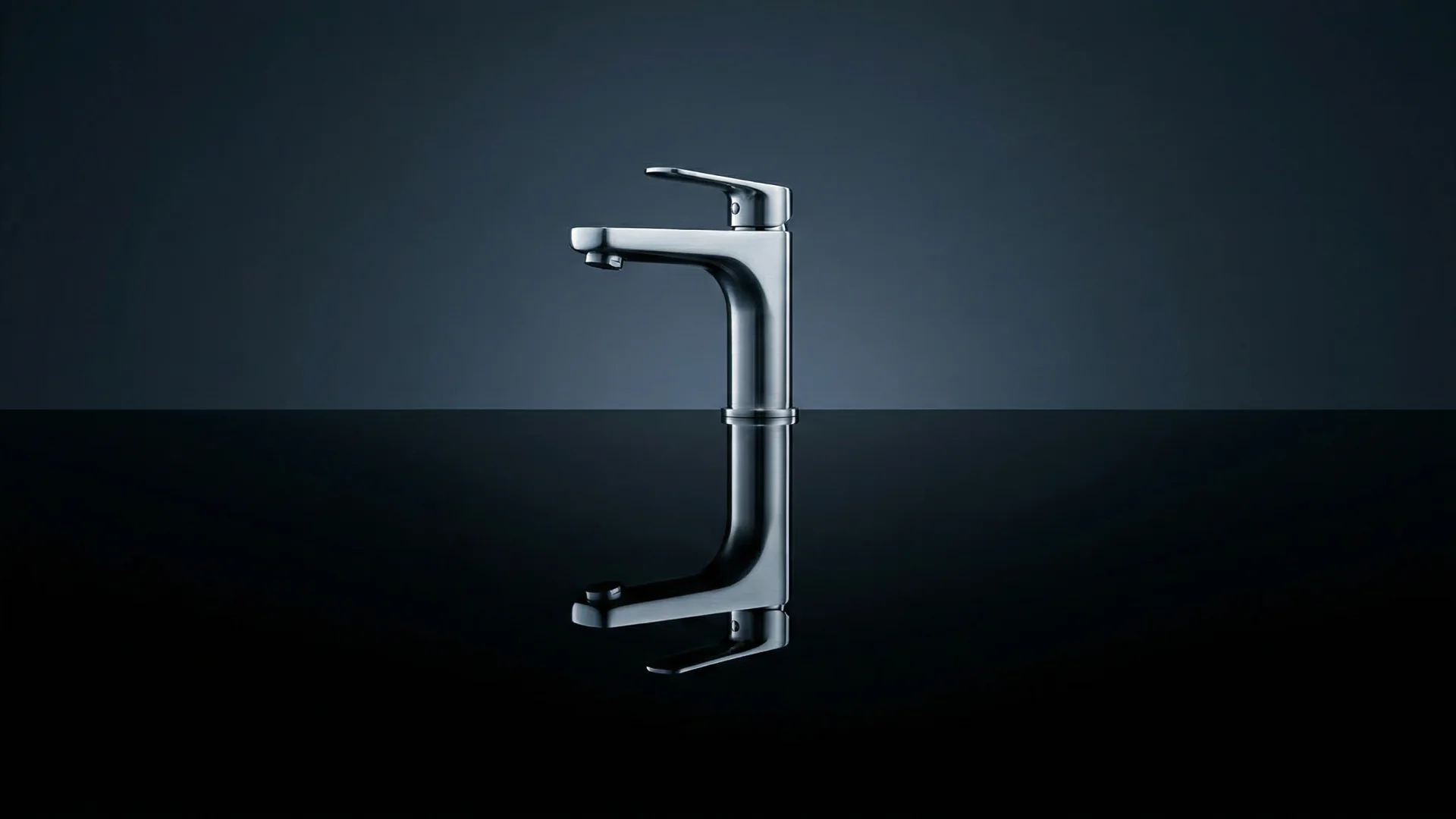 Modern chrome basin mixer faucet with a reflection on a glossy black surface.