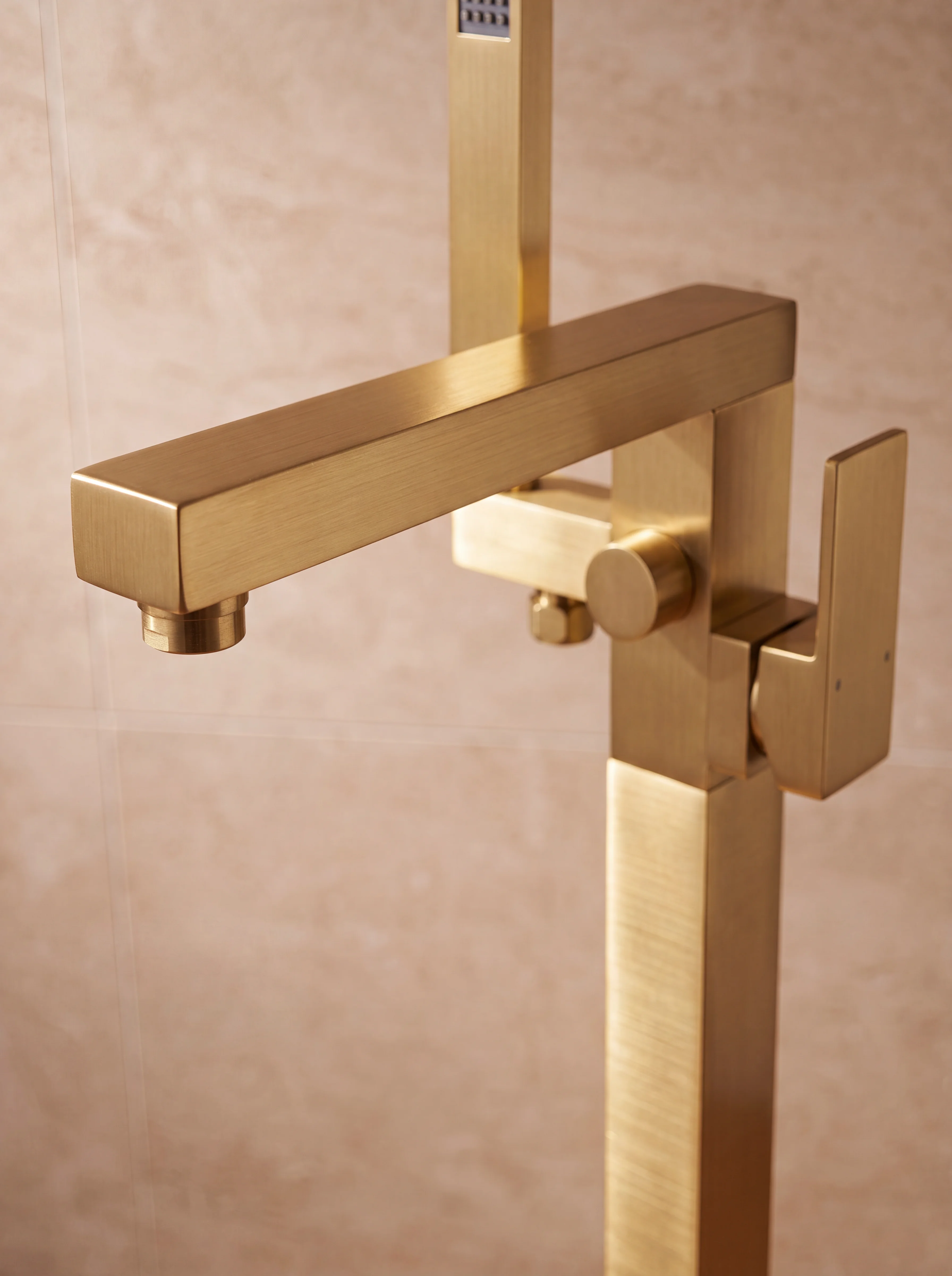 Doré bath filler detail — brushed gold square spout arm and handheld shower