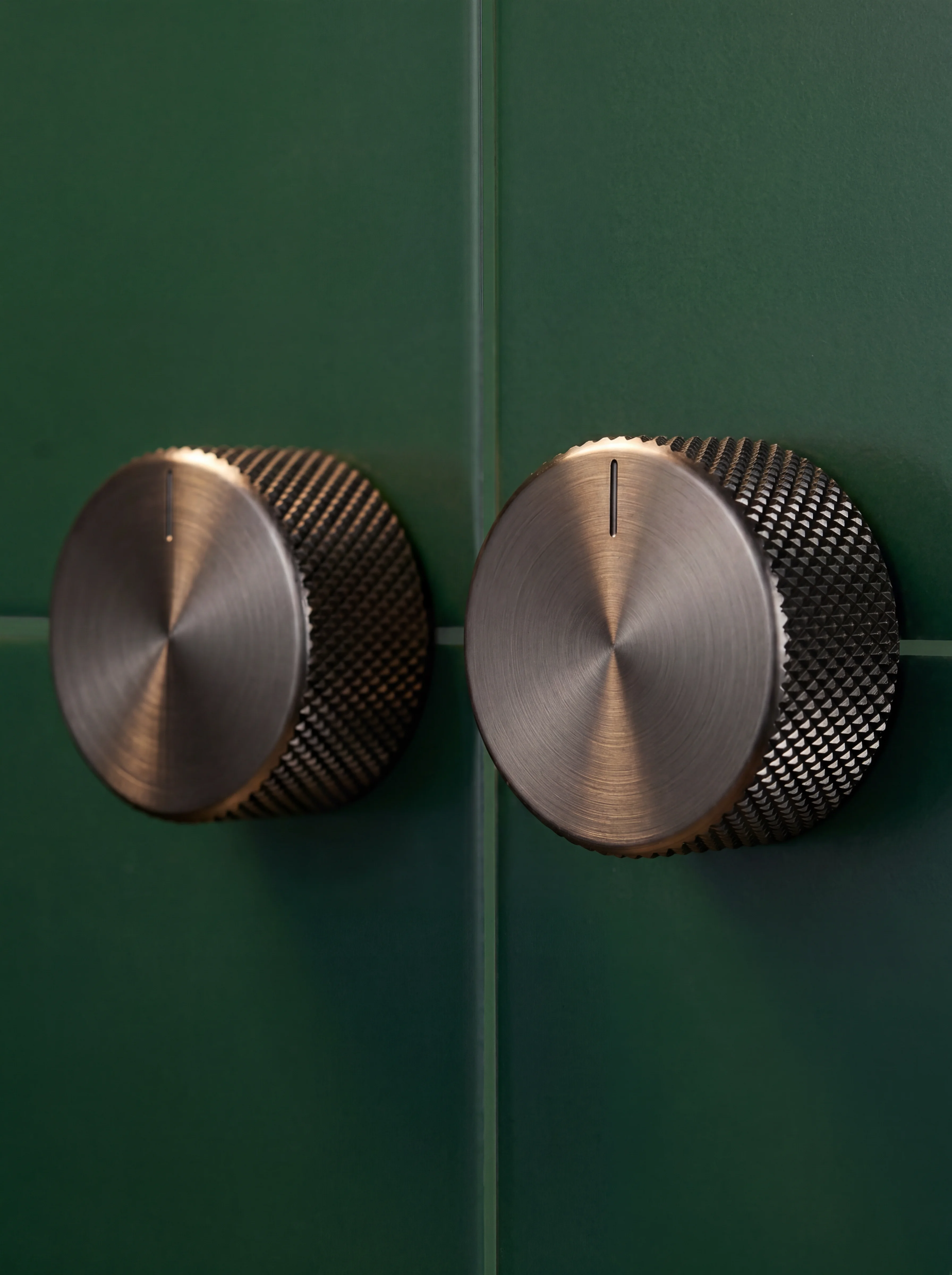Forge shower detail — knurled control dials and handset in brushed gunmetal