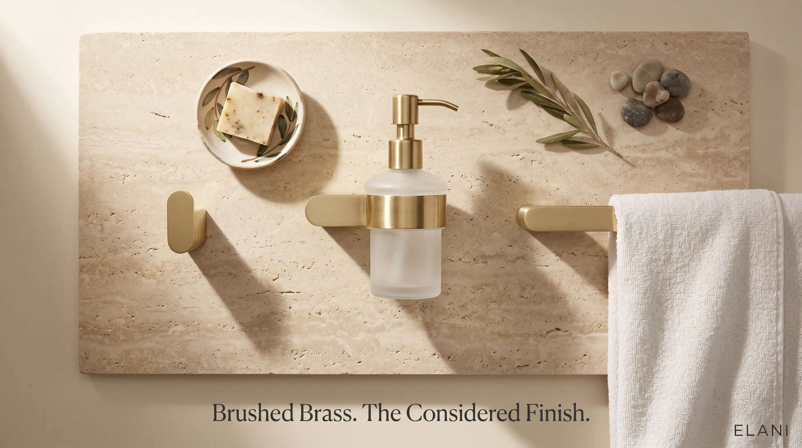 Styled flat lay of brushed brass bathroom accessories