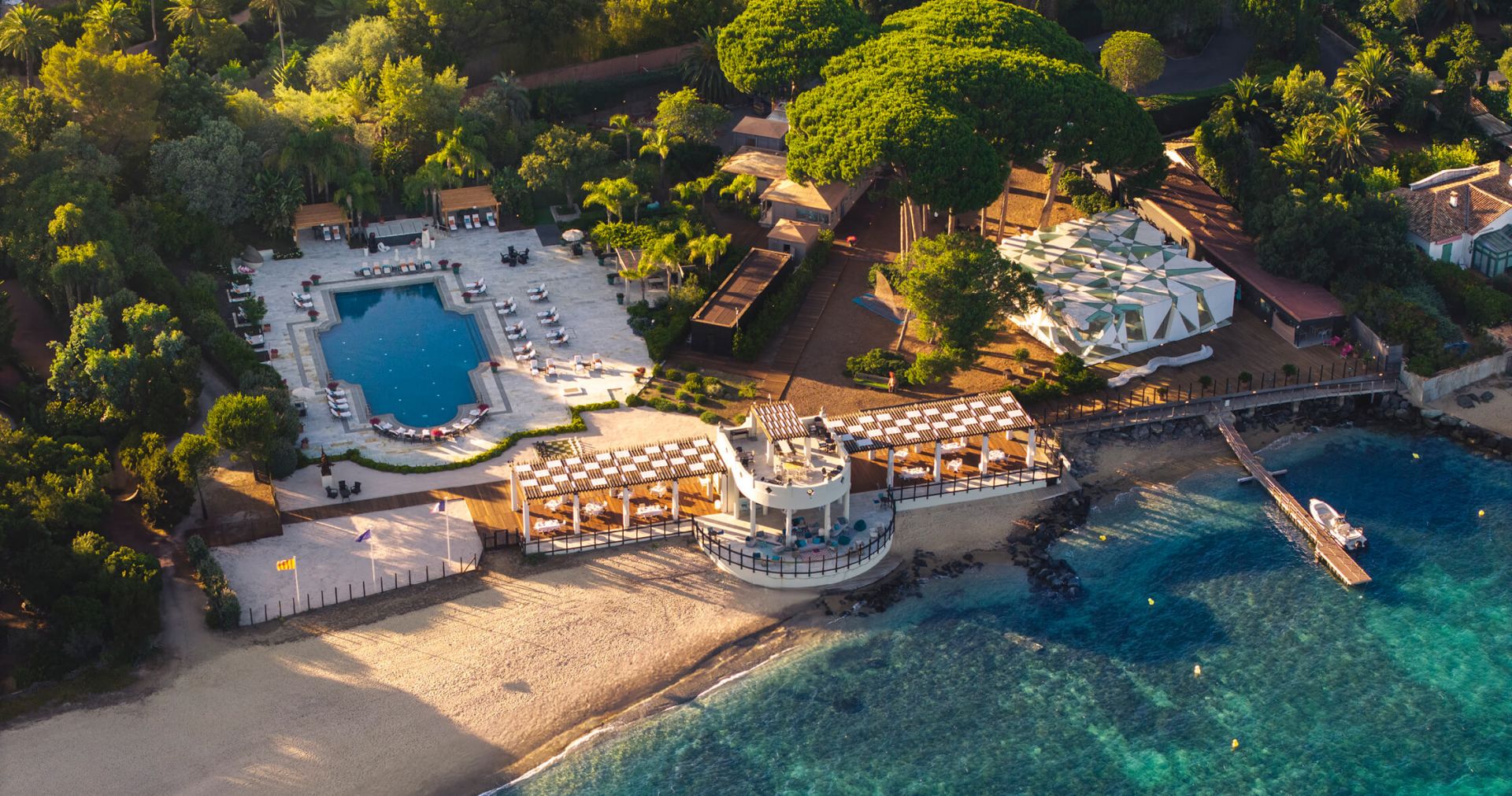 Aerial view of COMO Le Beauvallon beach club and pool on the Saint-Tropez seafront, opening in 2026