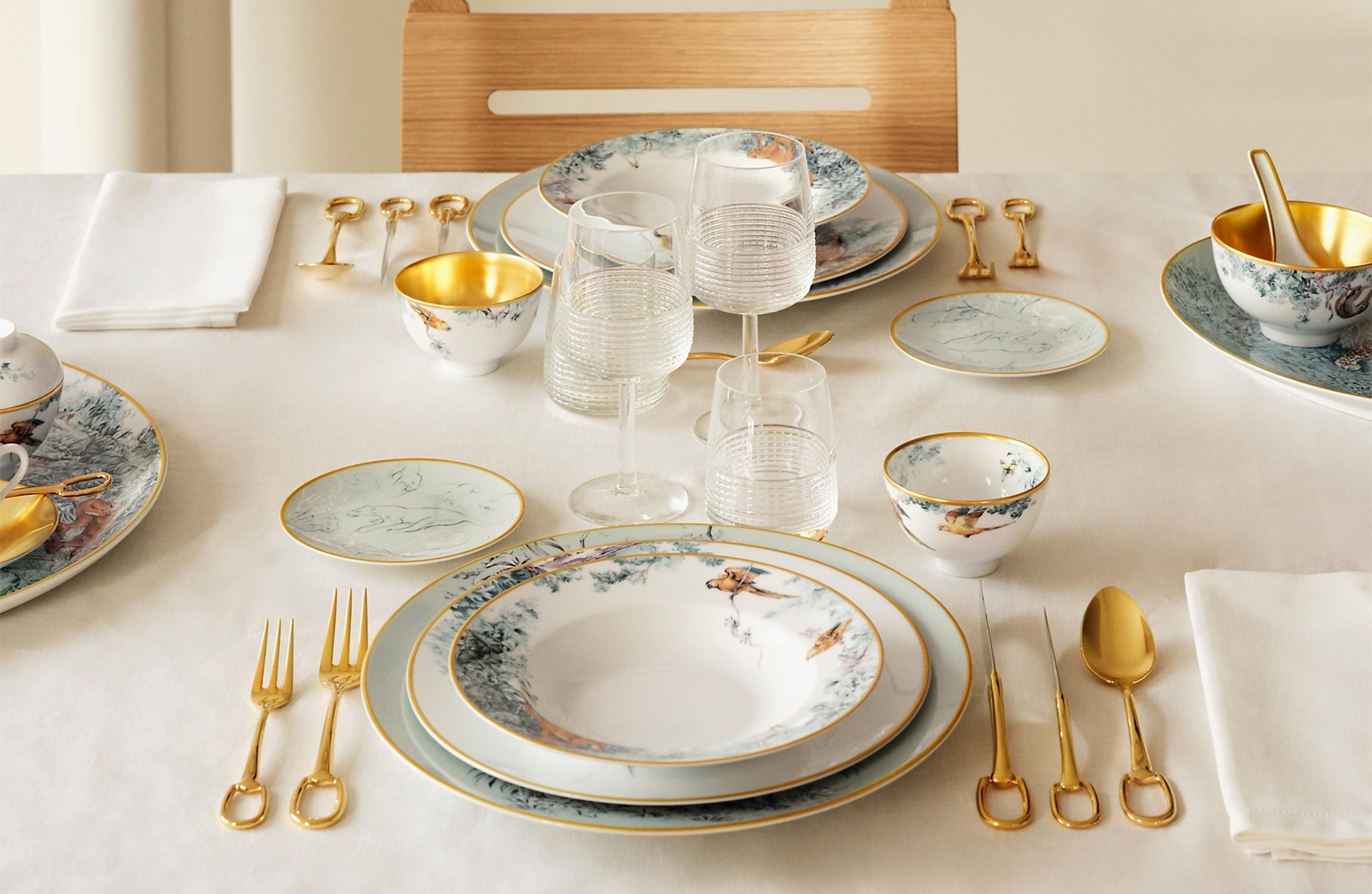 Hermès luxury tableware Carnets d’Équateur collection with gold-accented porcelain and fine dining setting