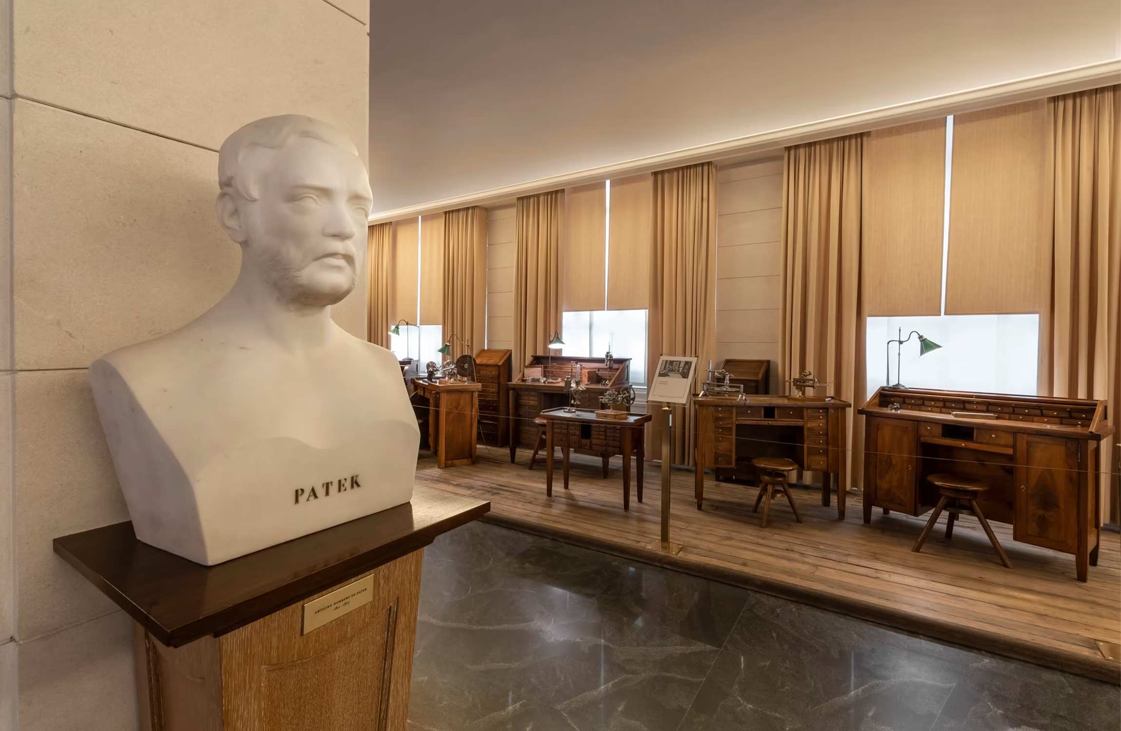 Historic pocket watches displayed inside the Patek Philippe Museum in Geneva showcasing rare gold cases, enamel craftsmanship, and early horological designs