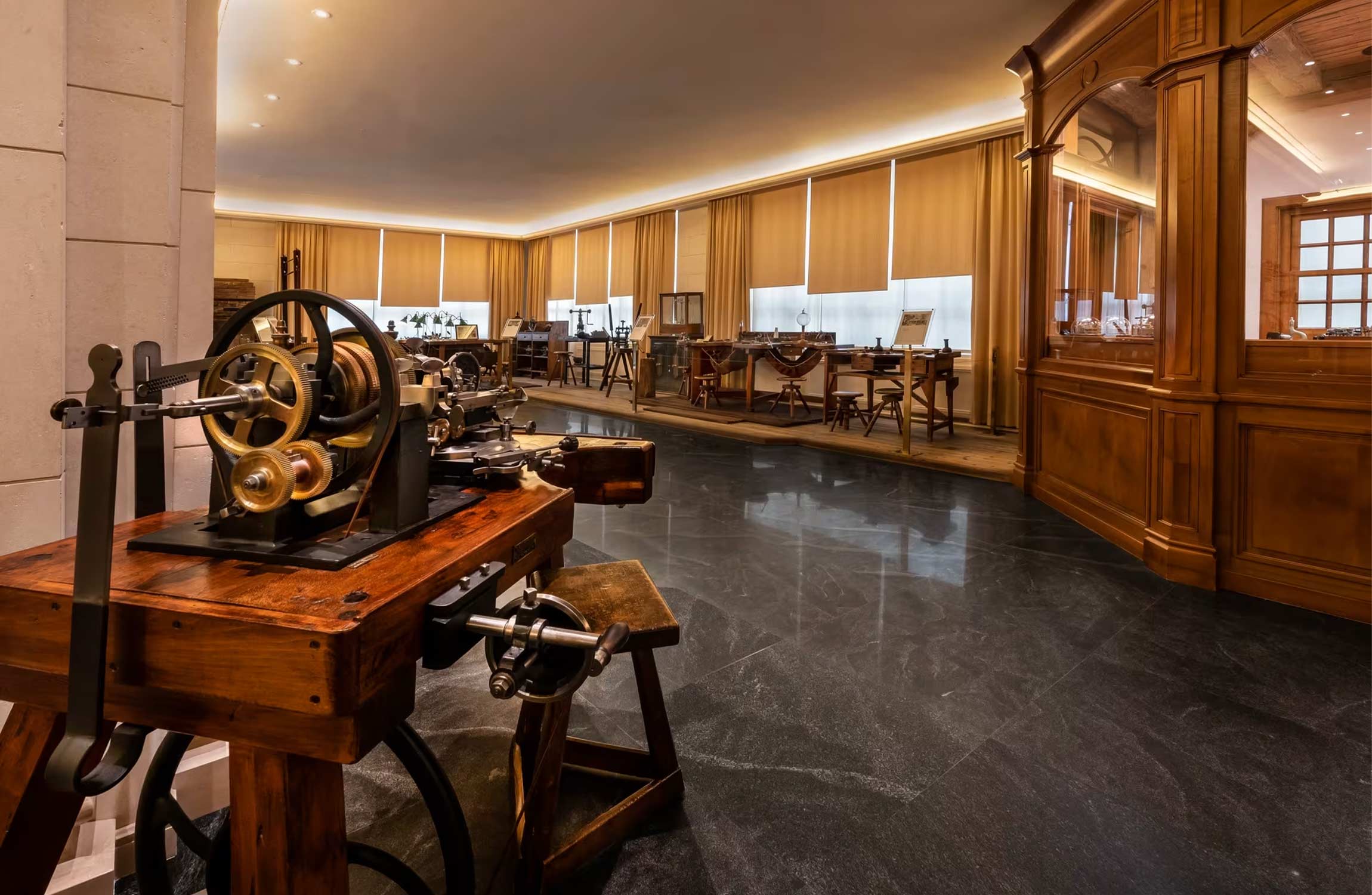 Historic watchmaking tools displayed inside the Patek Philippe Museum in Geneva showing traditional instruments used in early Swiss horology