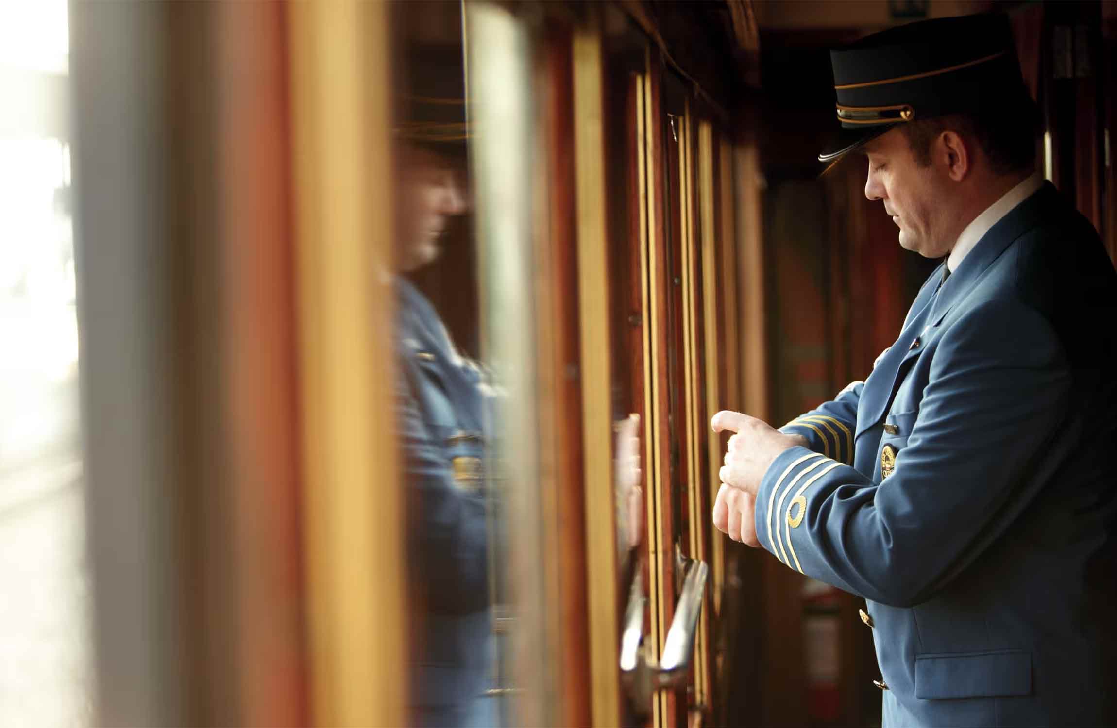 Cabin steward providing personalized service aboard the Venice Simplon-Orient-Express luxury train