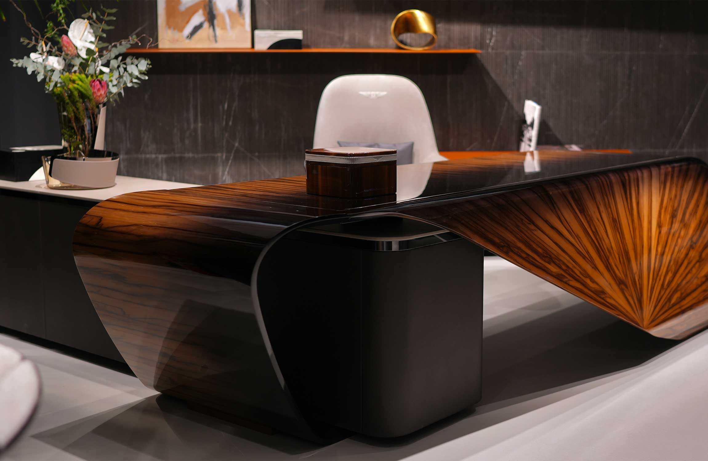 Bentley Home luxury executive desk crafted in sculptural wood design displayed in a premium interior showroom with refined modern décor.