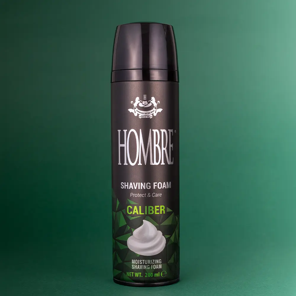 HOMBRE® Caliber shaving foam for men on dark green background — fougère masculine scent