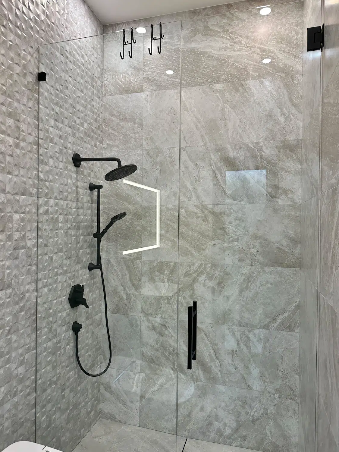 Verified customer bathroom renovation project by ArtivaTile featuring a custom walk-in shower, large-format porcelain tile, and premium black fixtures.