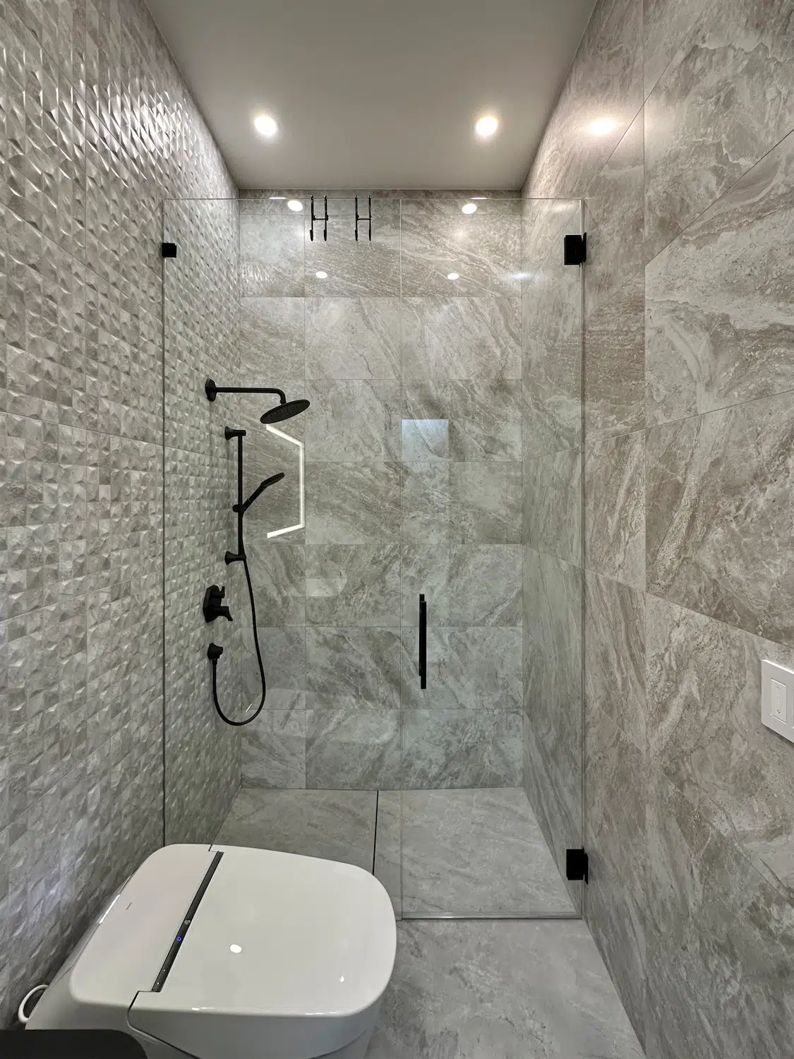 Customer review showcasing a completed luxury bathroom and shower renovation by ArtivaTile in Miami, featuring large-format porcelain tile and frameless glass enclosure.