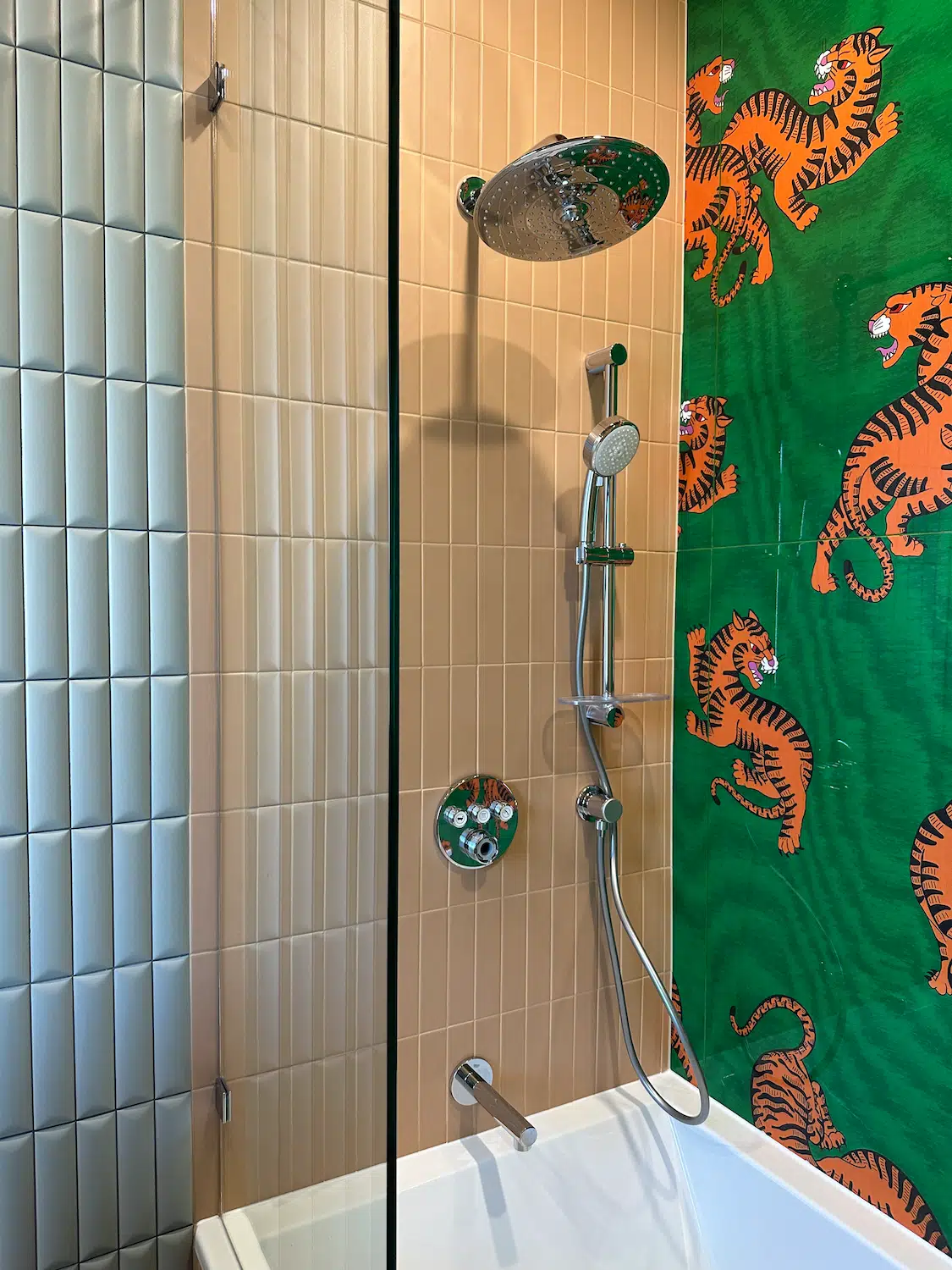 Bathtub shower renovation with decorative accent tile wall, vertical porcelain tile, and frameless glass enclosure installed in Miami.