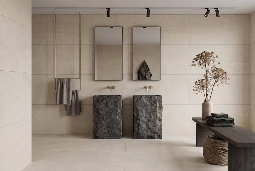 Modern luxury bathroom remodel featuring large-format porcelain tile, freestanding stone vessel sinks, floating wall-mounted faucets, and precision tile installation in Miami.