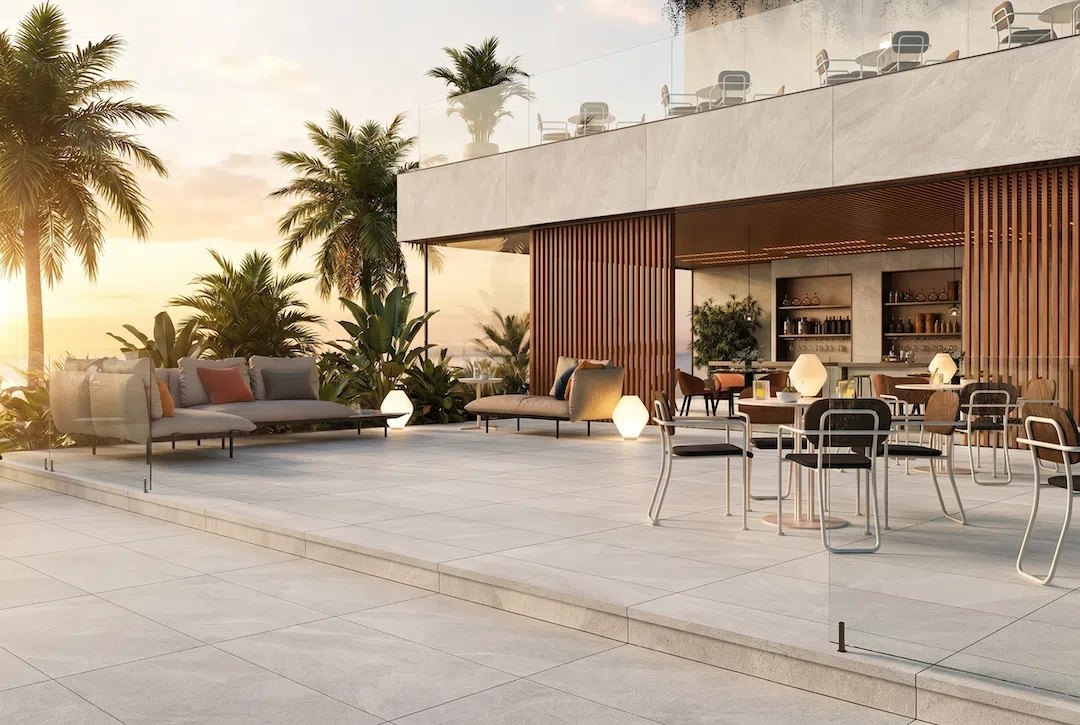 Luxury outdoor living space featuring large-format porcelain patio tile, seamless indoor-outdoor transitions, and premium tile installation in a Miami residence.
