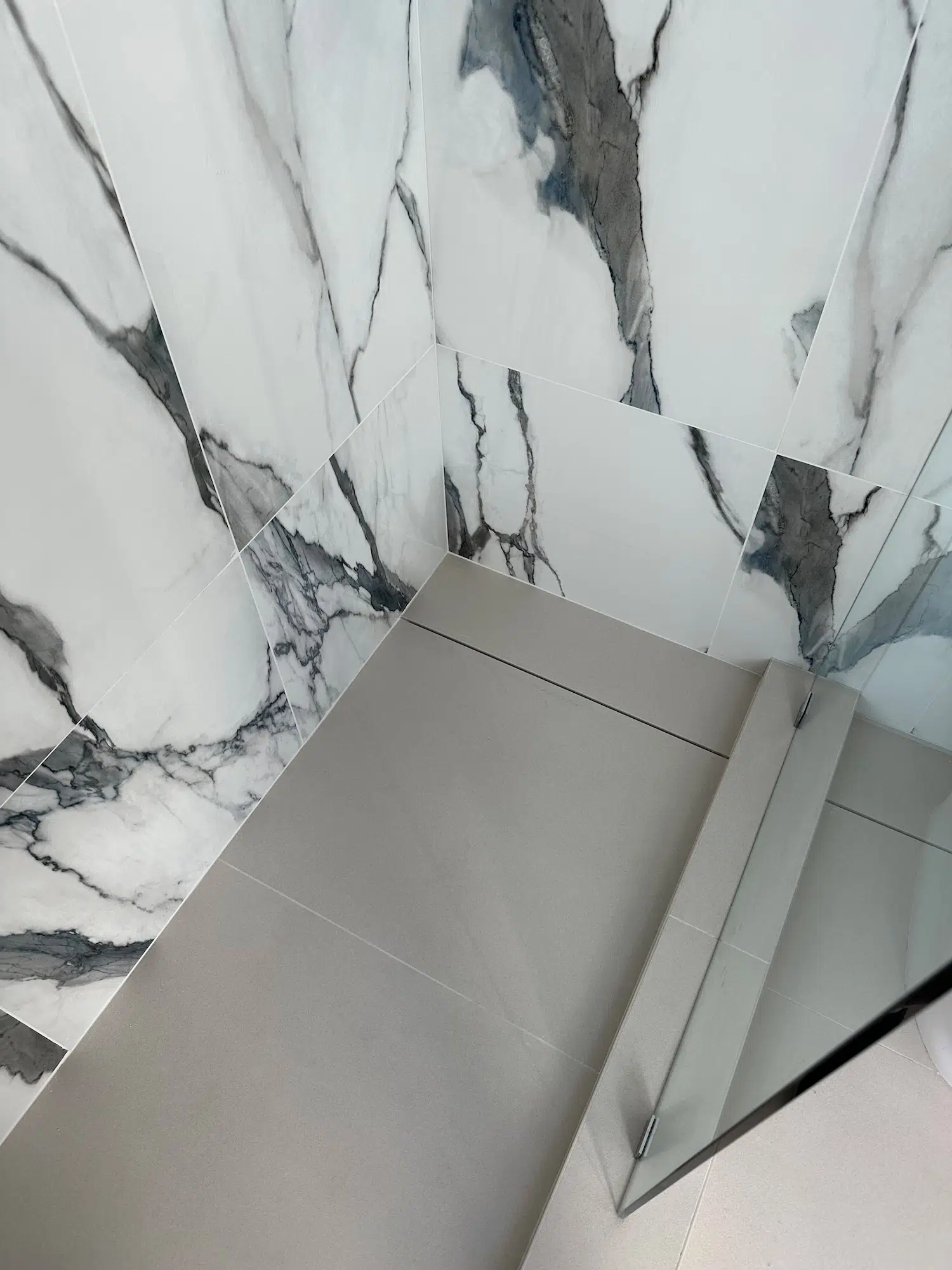 Custom shower pan installation with linear drain minimal style