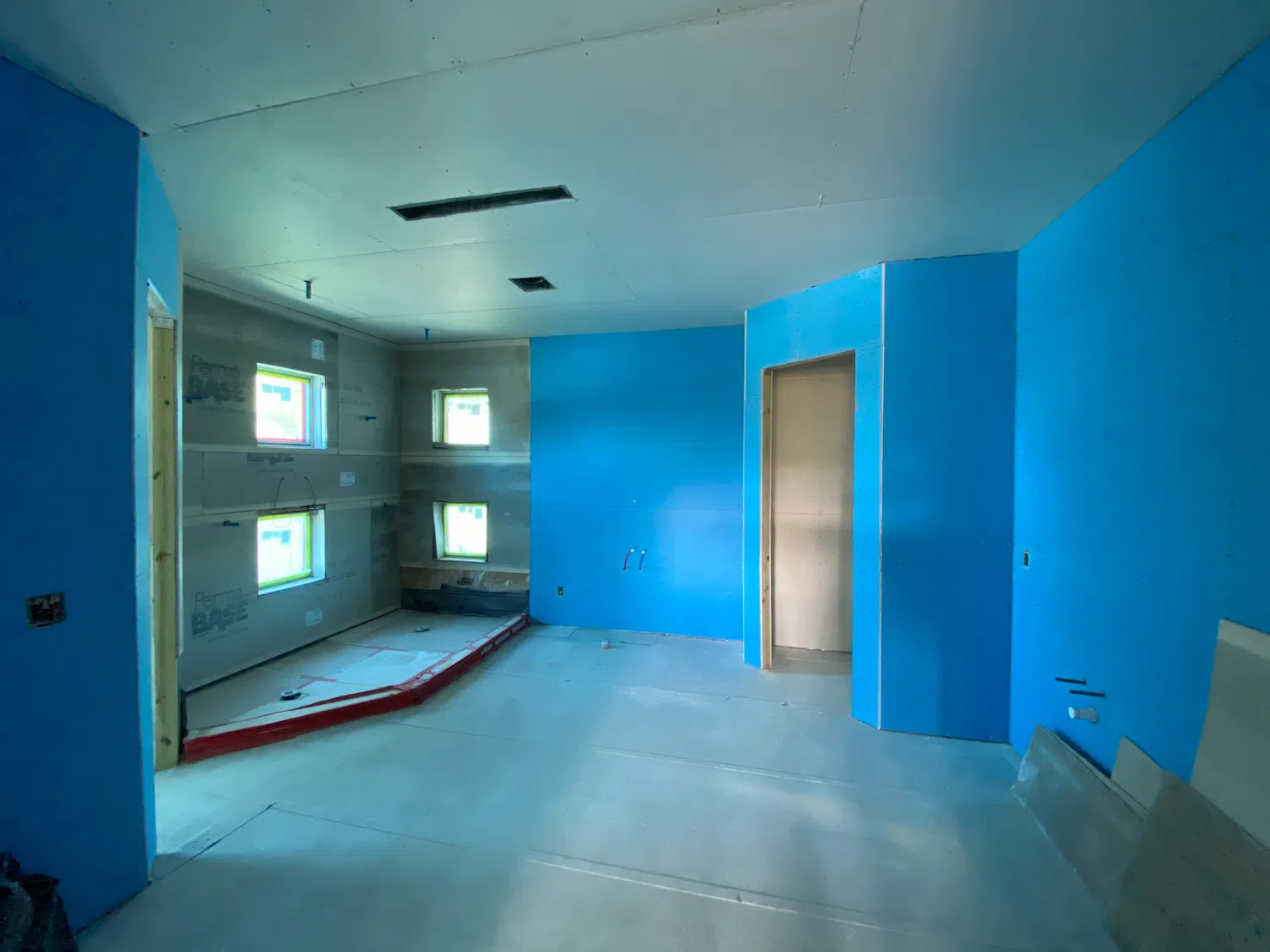 Bathroom under construction in Fort Lauderdale, FL, with exposed wall boards, plumbing connections, and an unfinished shower area.”