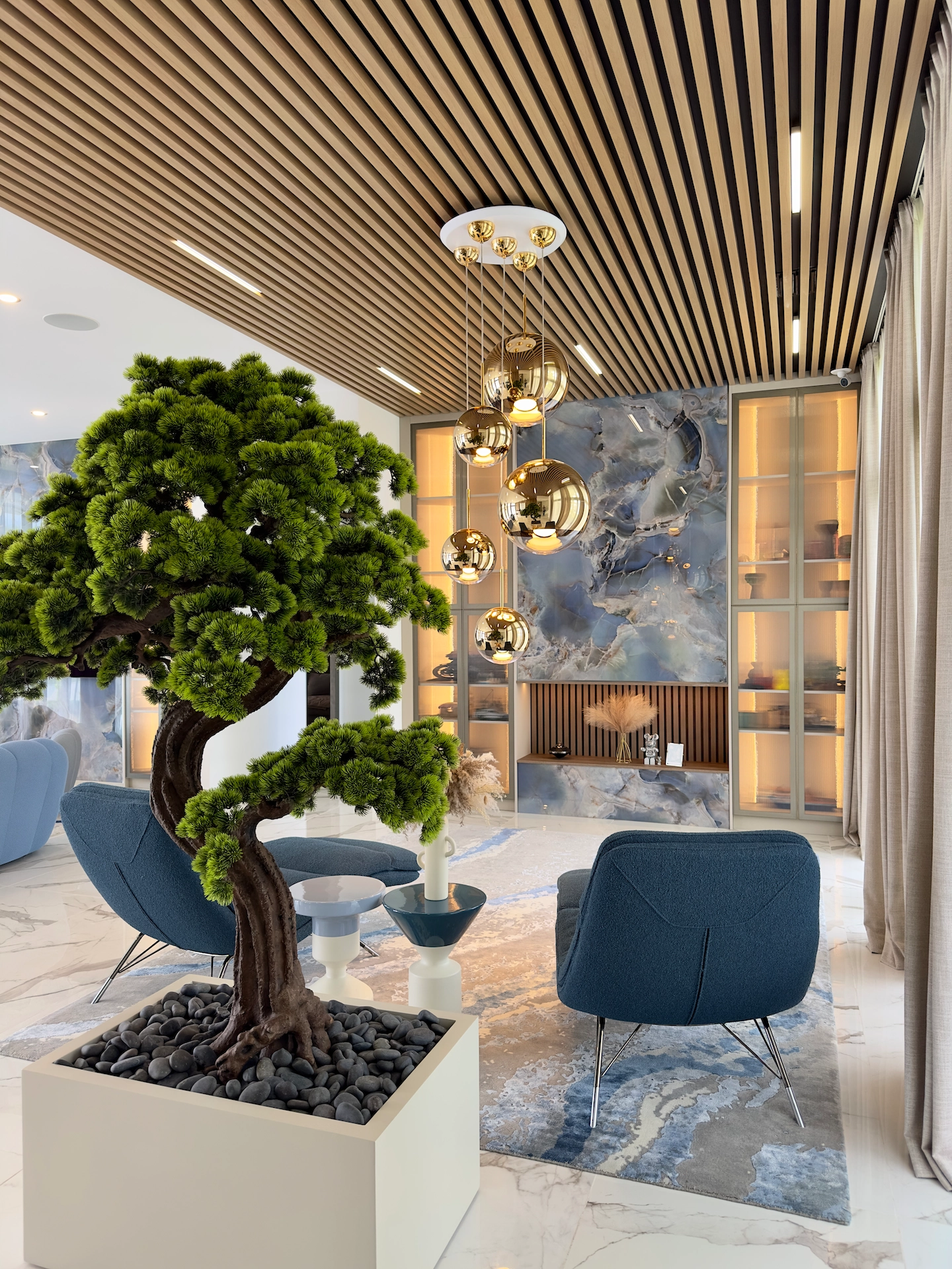 Detail view of wood slat ceiling and porcelain slab accent wall installation