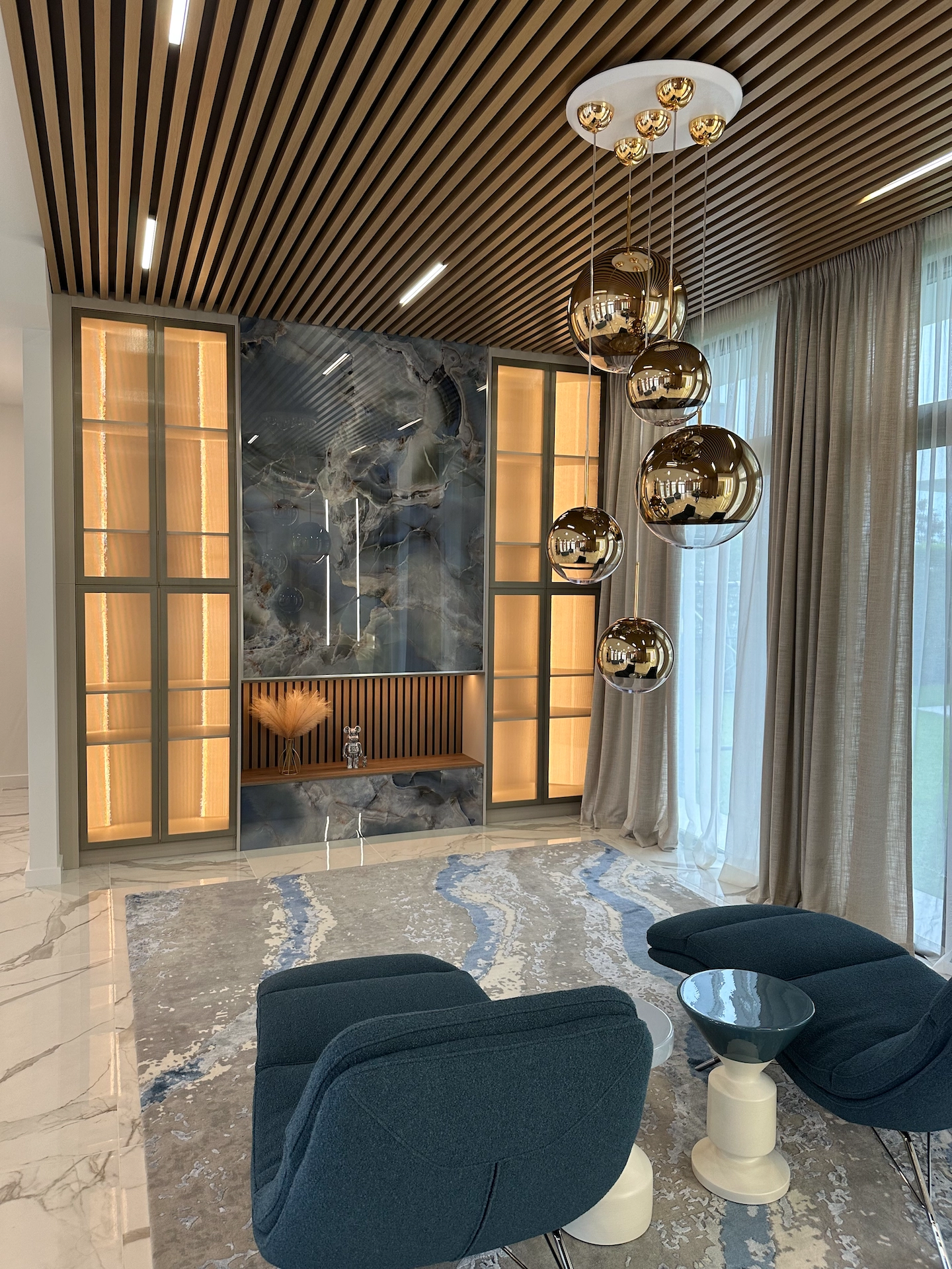 Custom architectural wall panels and slab tile installation surrounding mounted television