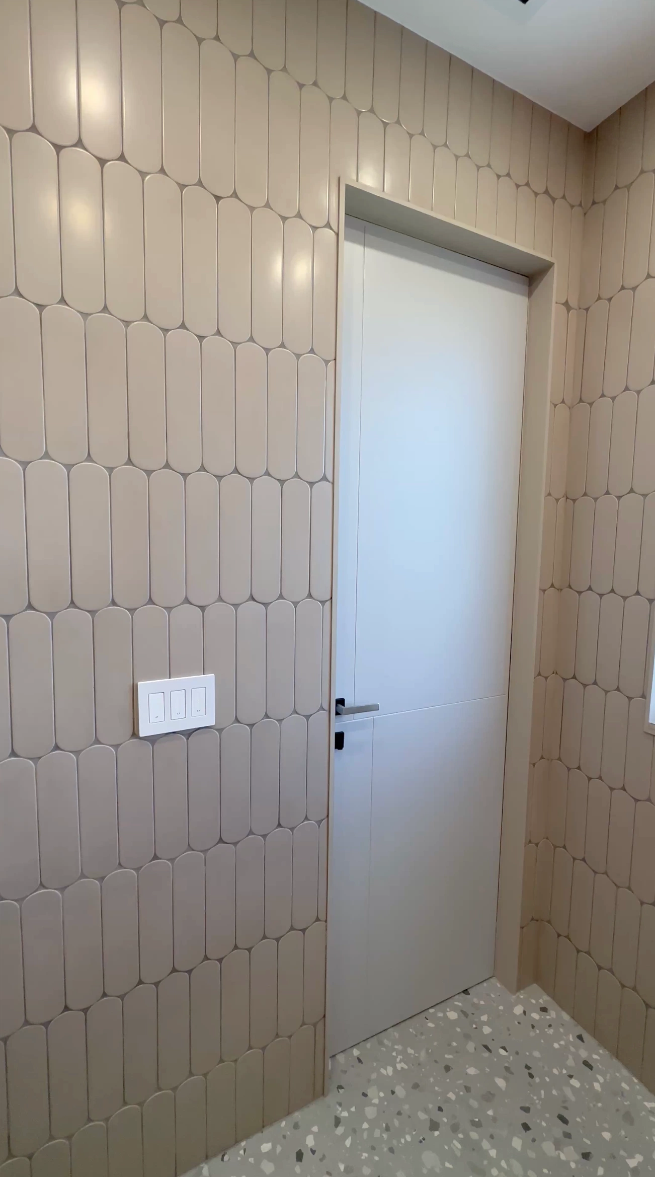 Hand-installed subway tile with even grout lines in Miami bathroom around door
