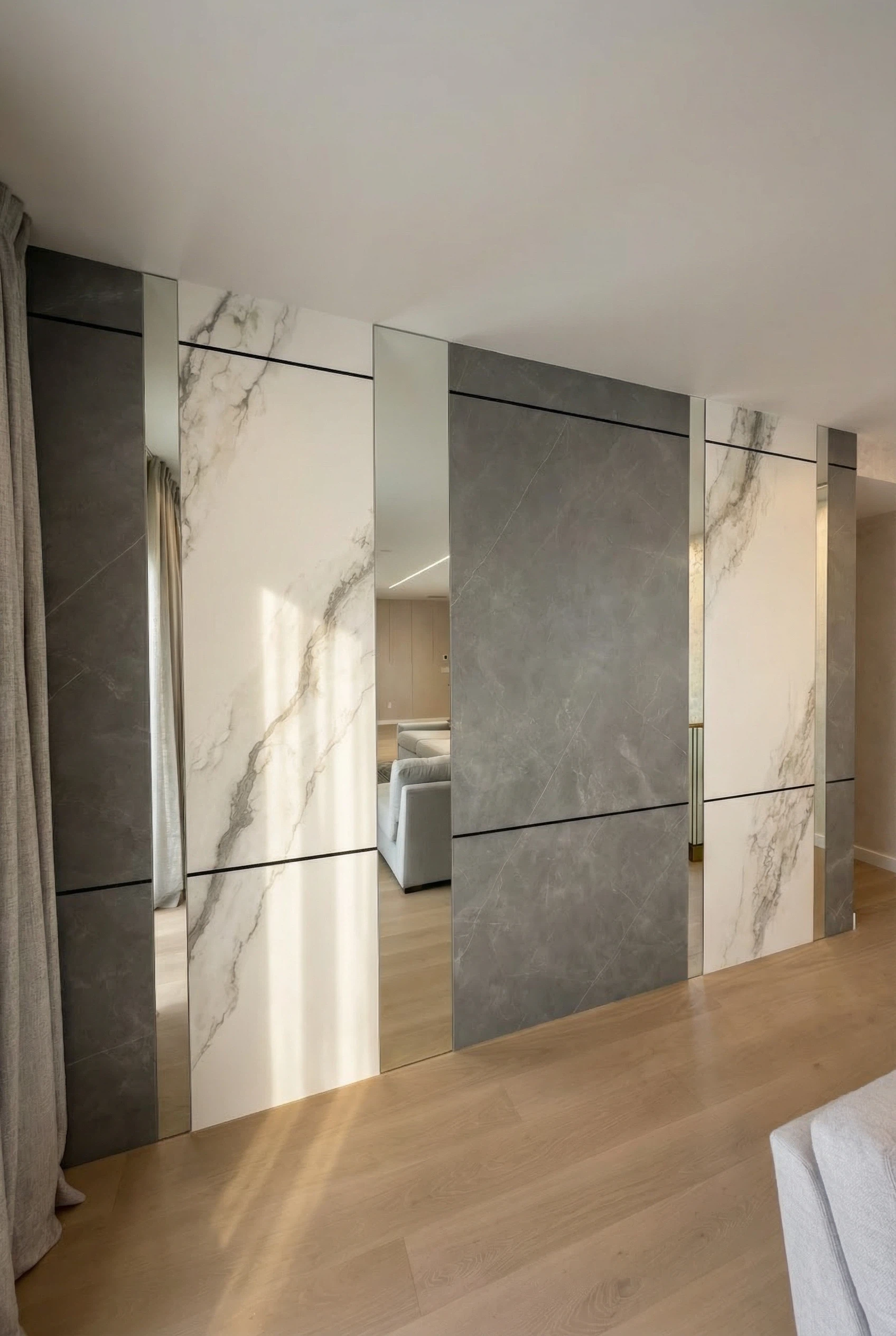 Architectural slab wall panels with integrated mirror detailing in Miami residence