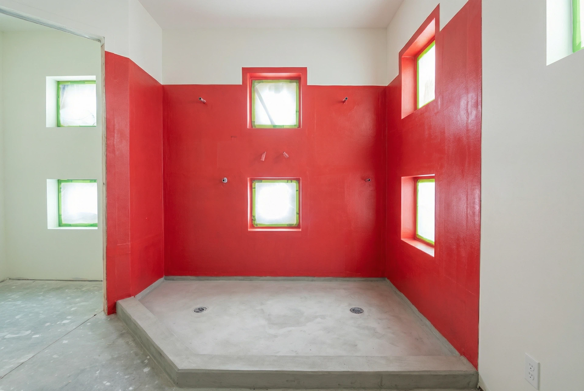 Shower waterproofing membrane installed on walls and pan before tile installation in Miami residence