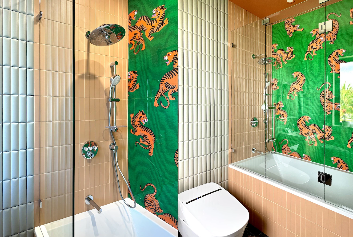 Bathroom renovation featuring bold jungle-themed accent wall and modern glass shower enclosure