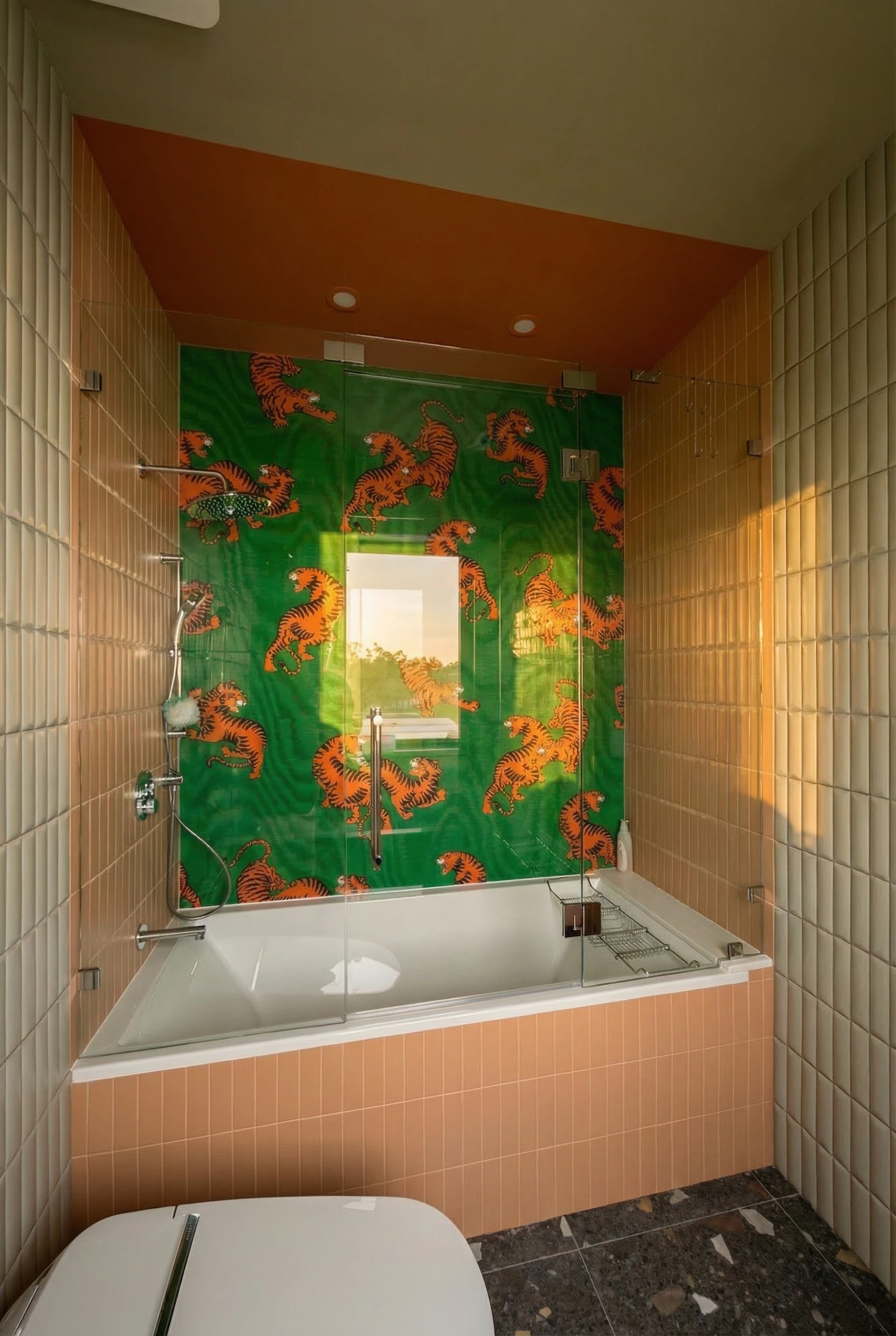 Walk-in shower with vertical beige wall tiles and contemporary chrome fixtures