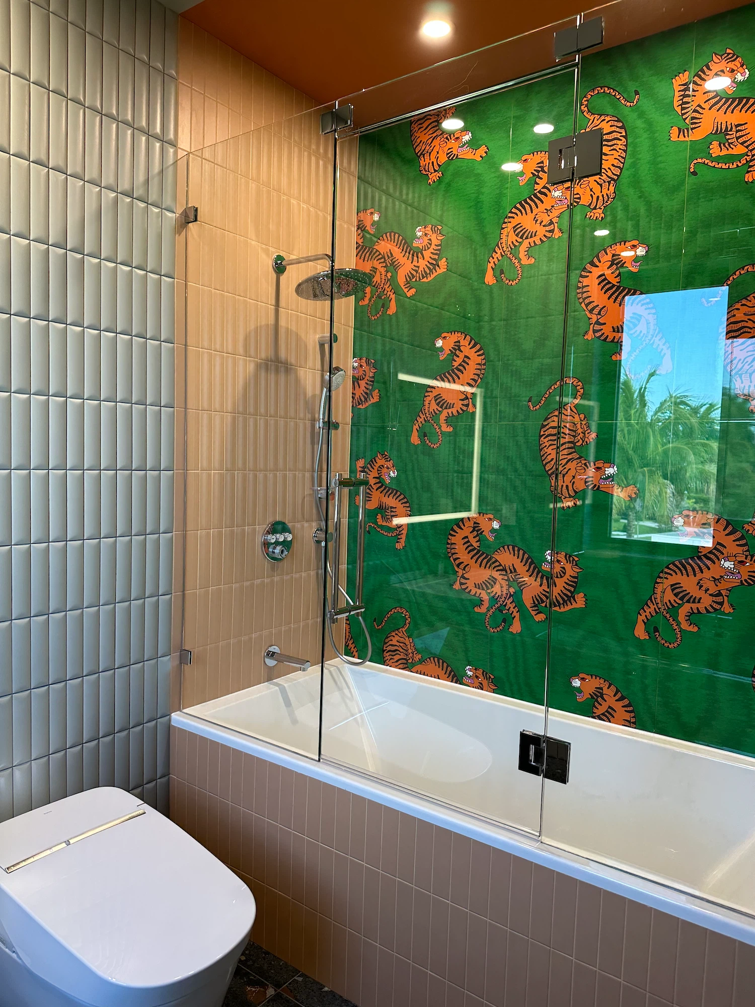 Contemporary bathroom with patterned accent wall and neutral surrounding tile installation