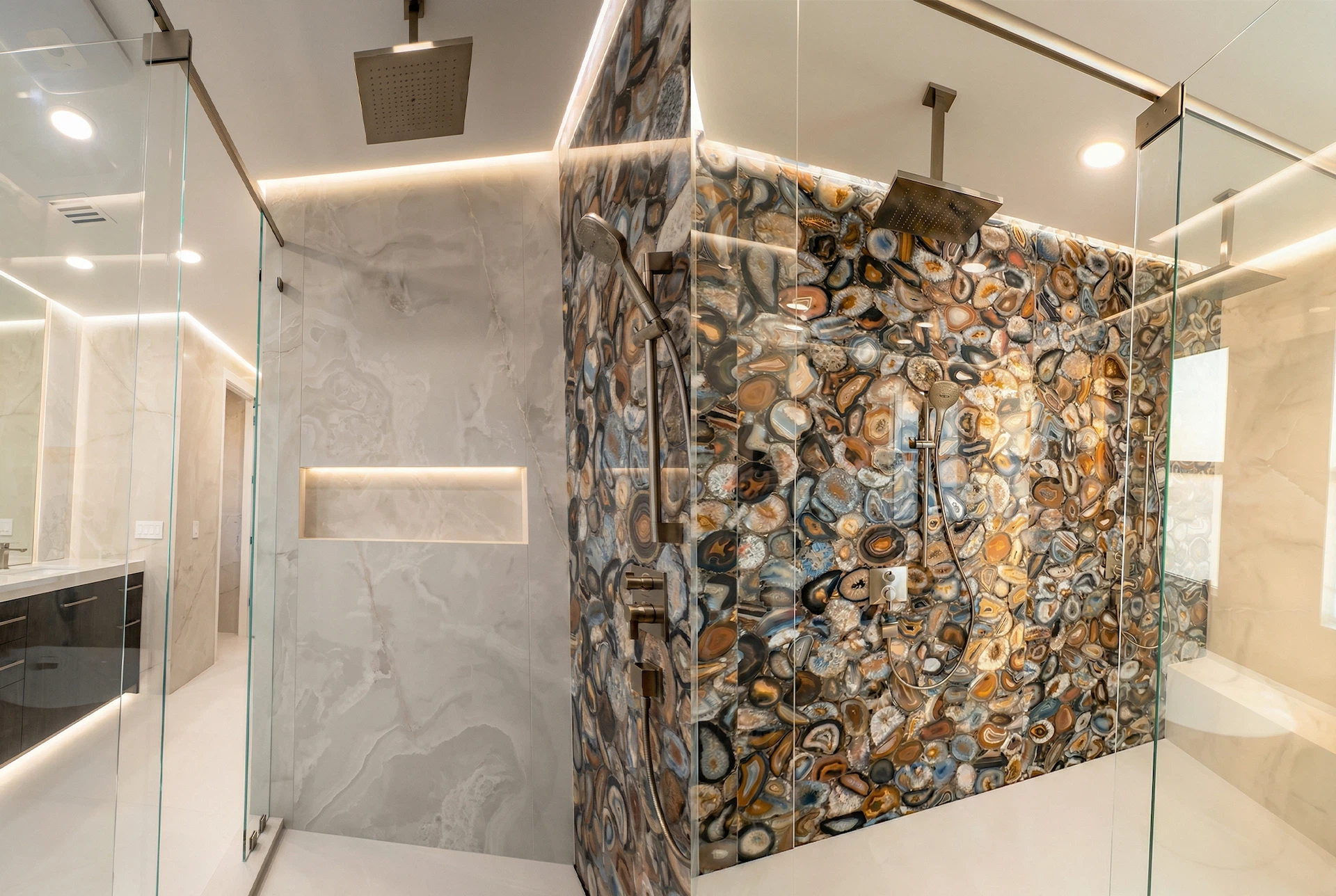 Luxury master bathroom with mosaic feature wall, freestanding bathtub, and glass shower enclosure in Parkland home