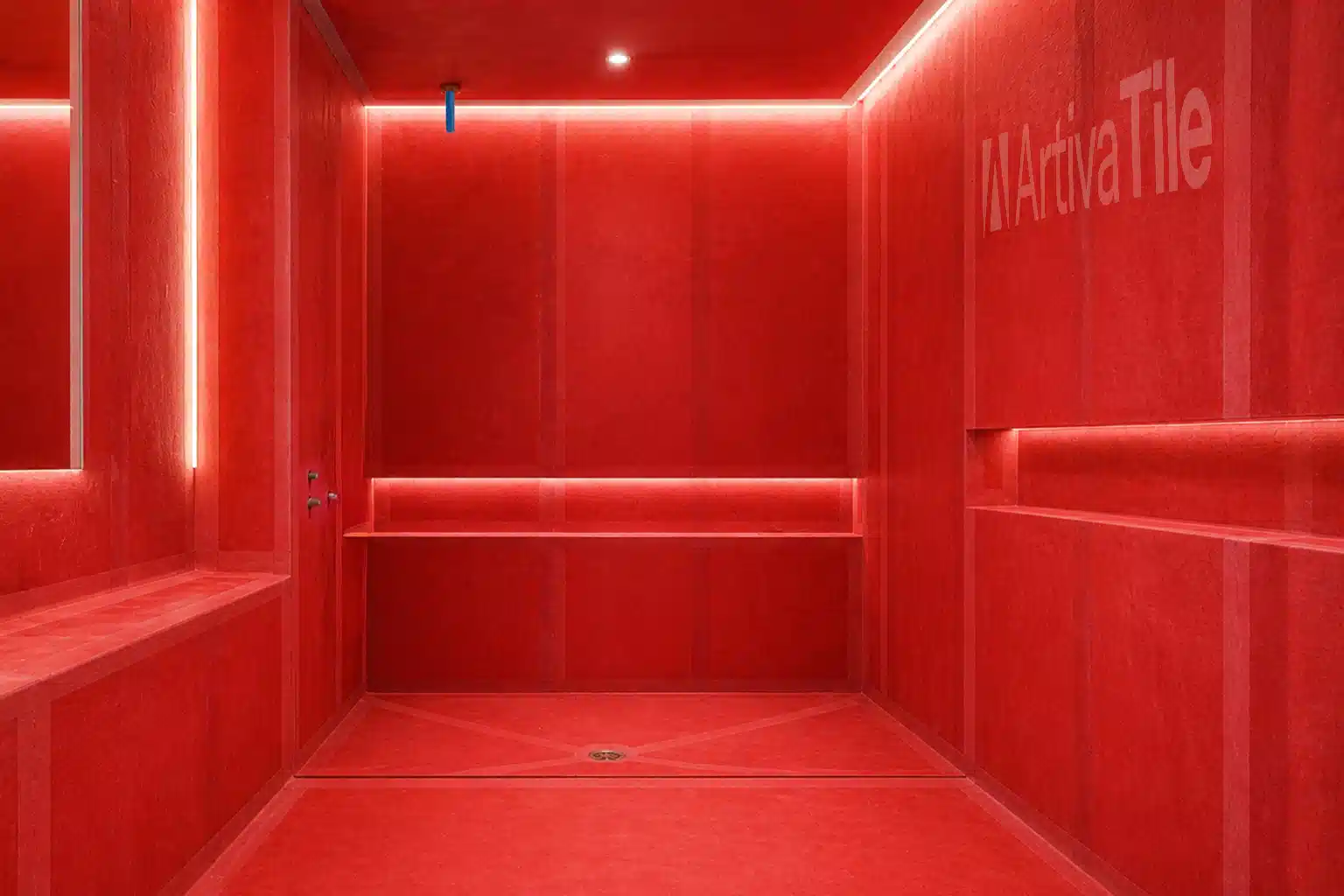 Fully waterproofed shower with red membrane system applied on walls and pre-sloped base before tile installation in Miami bathroom