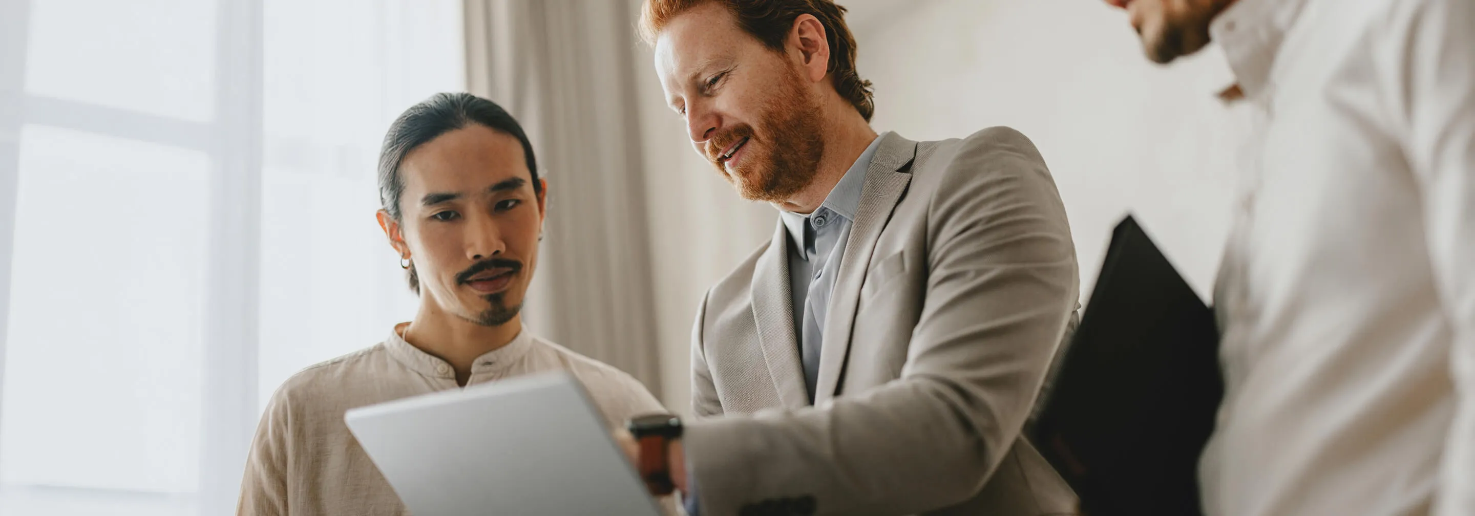 Two professionals reviewing SAP advisory strategy on a laptop
