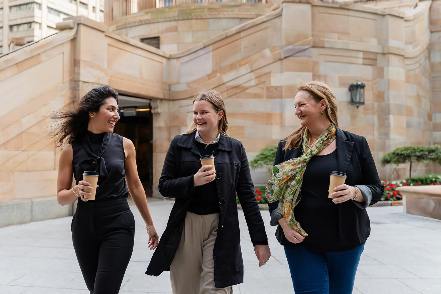 Three professional women having a business meeting outdoors