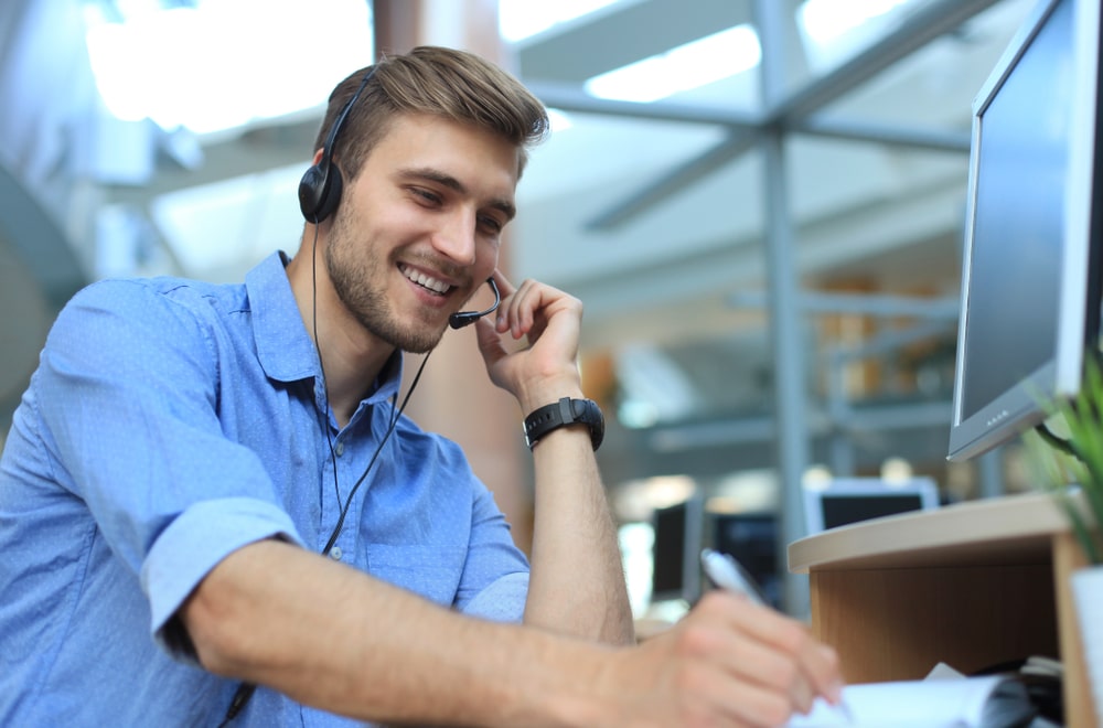 A man works at a customer support desk