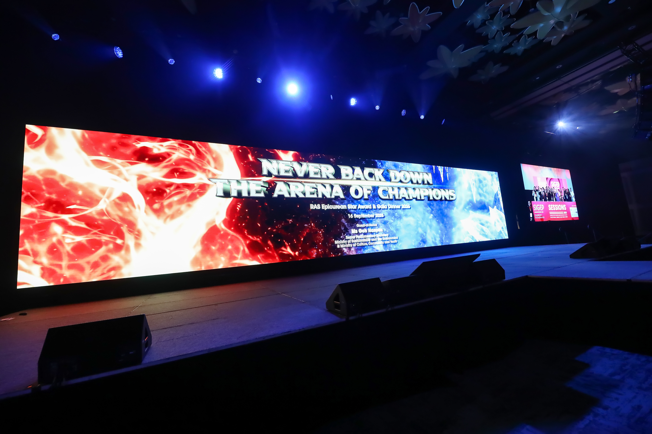 The stage at the Epicurean Star Award and Gala Dinner 2026, lit with the theme Never Back Down: The Arena of Champions