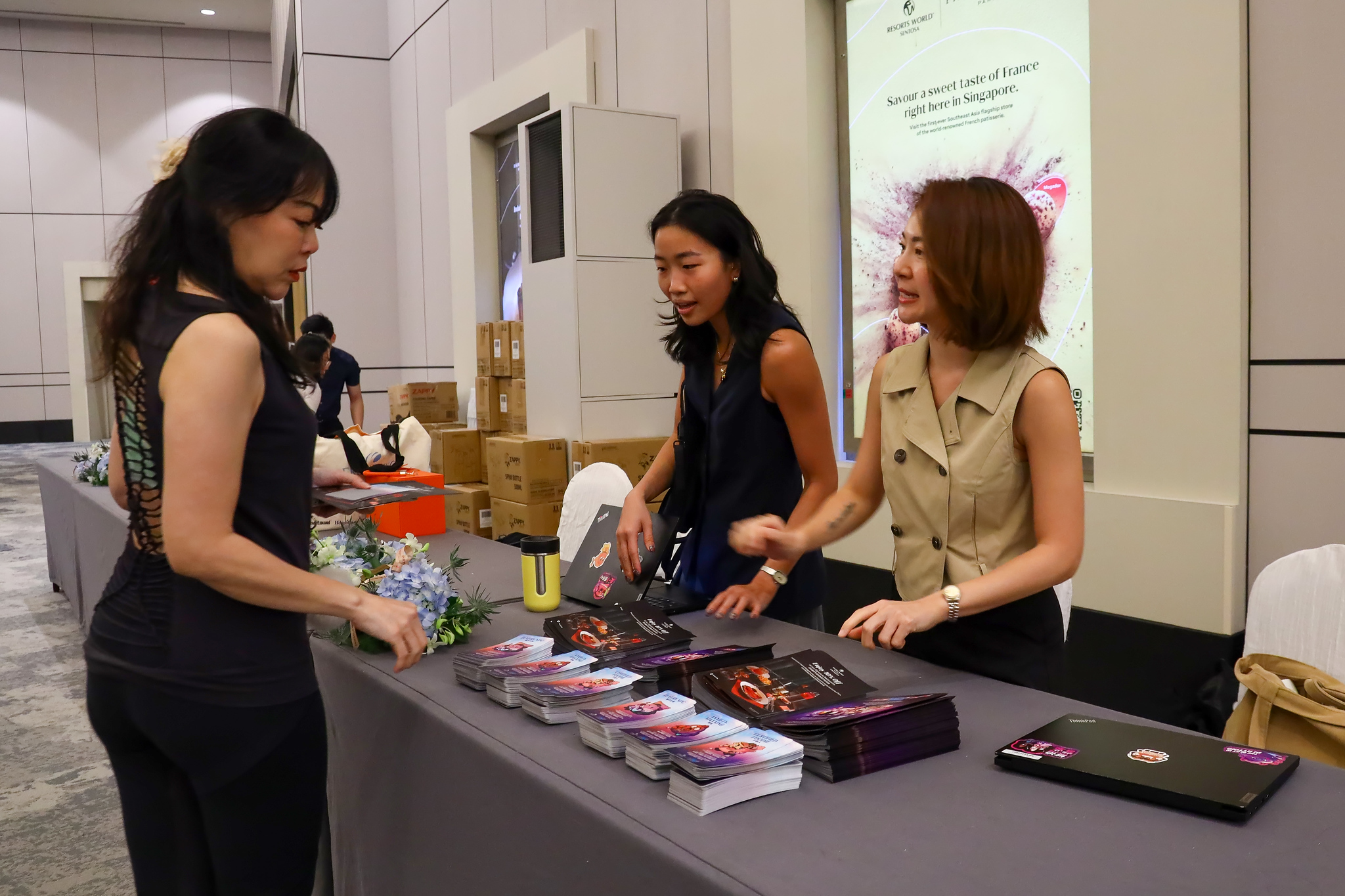 Exhibitors welcoming guests at their booth
