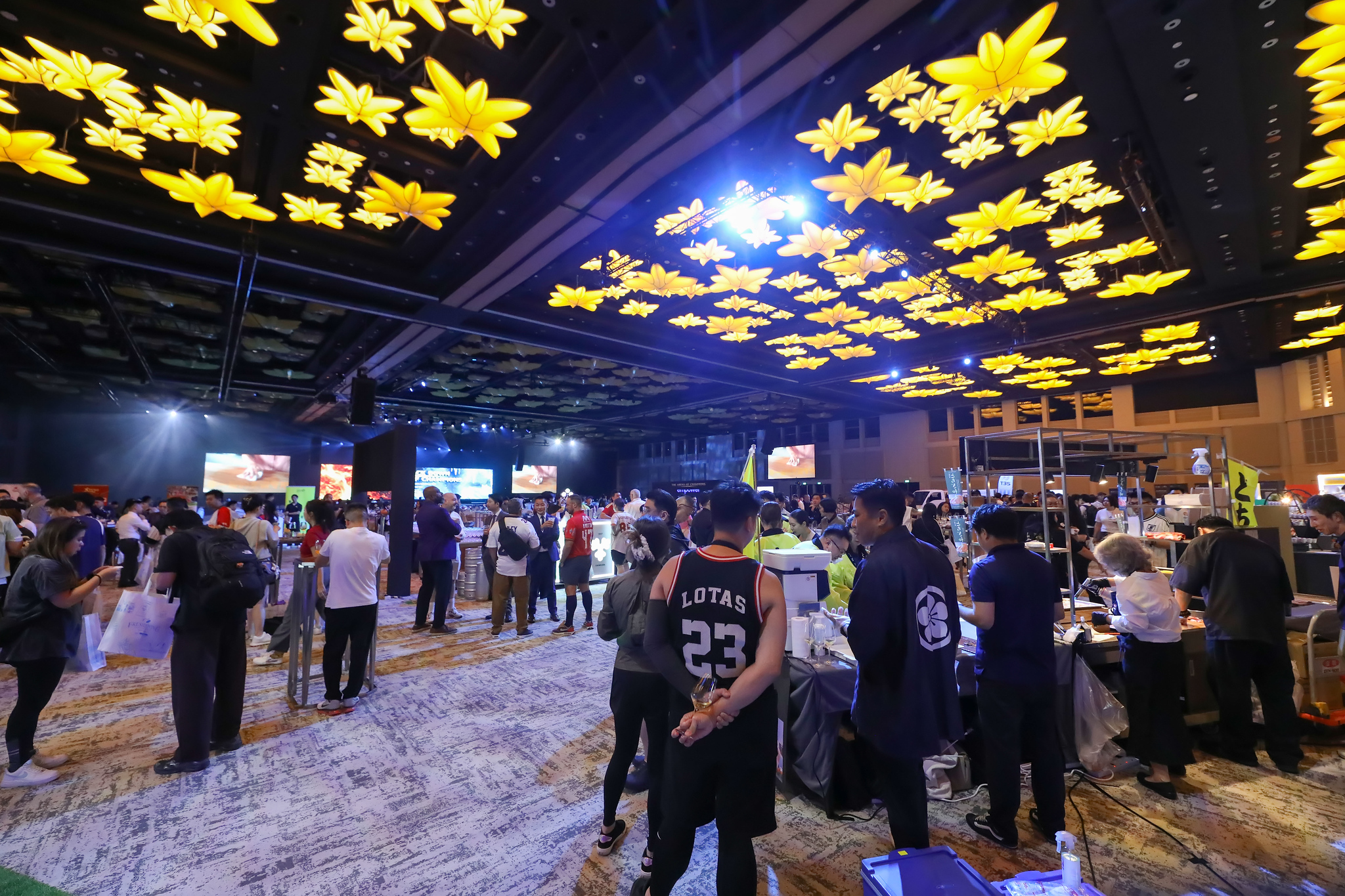 The showcase floor fills up under the golden ceiling