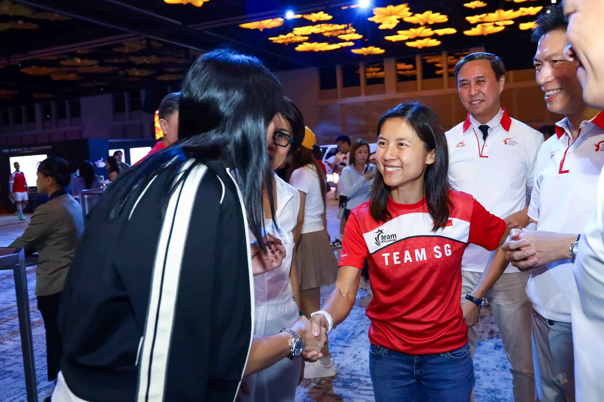 A Team SG athlete greets guests on the showcase floor