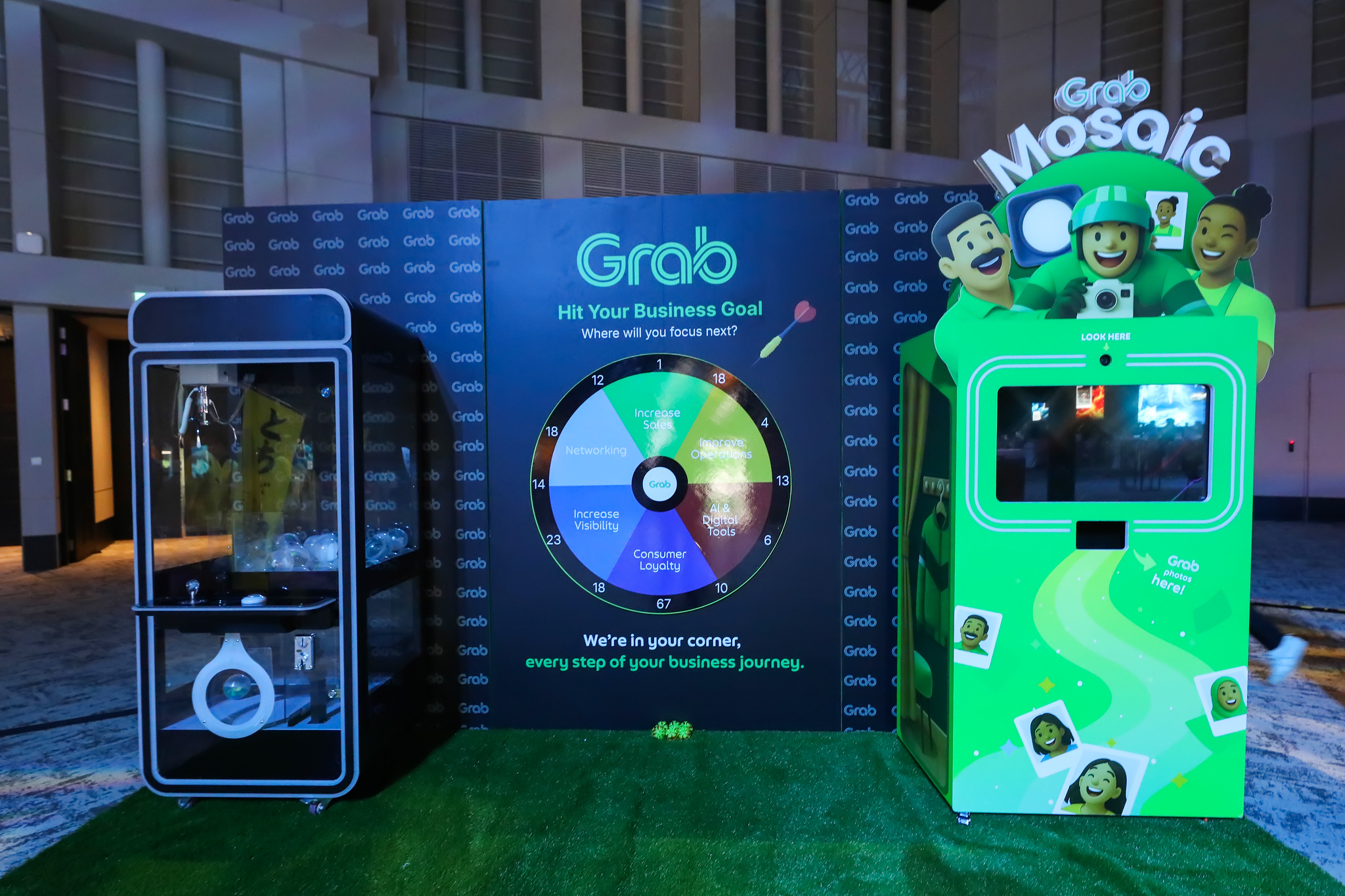 Grab's interactive booth with a prize wheel and photo kiosk
