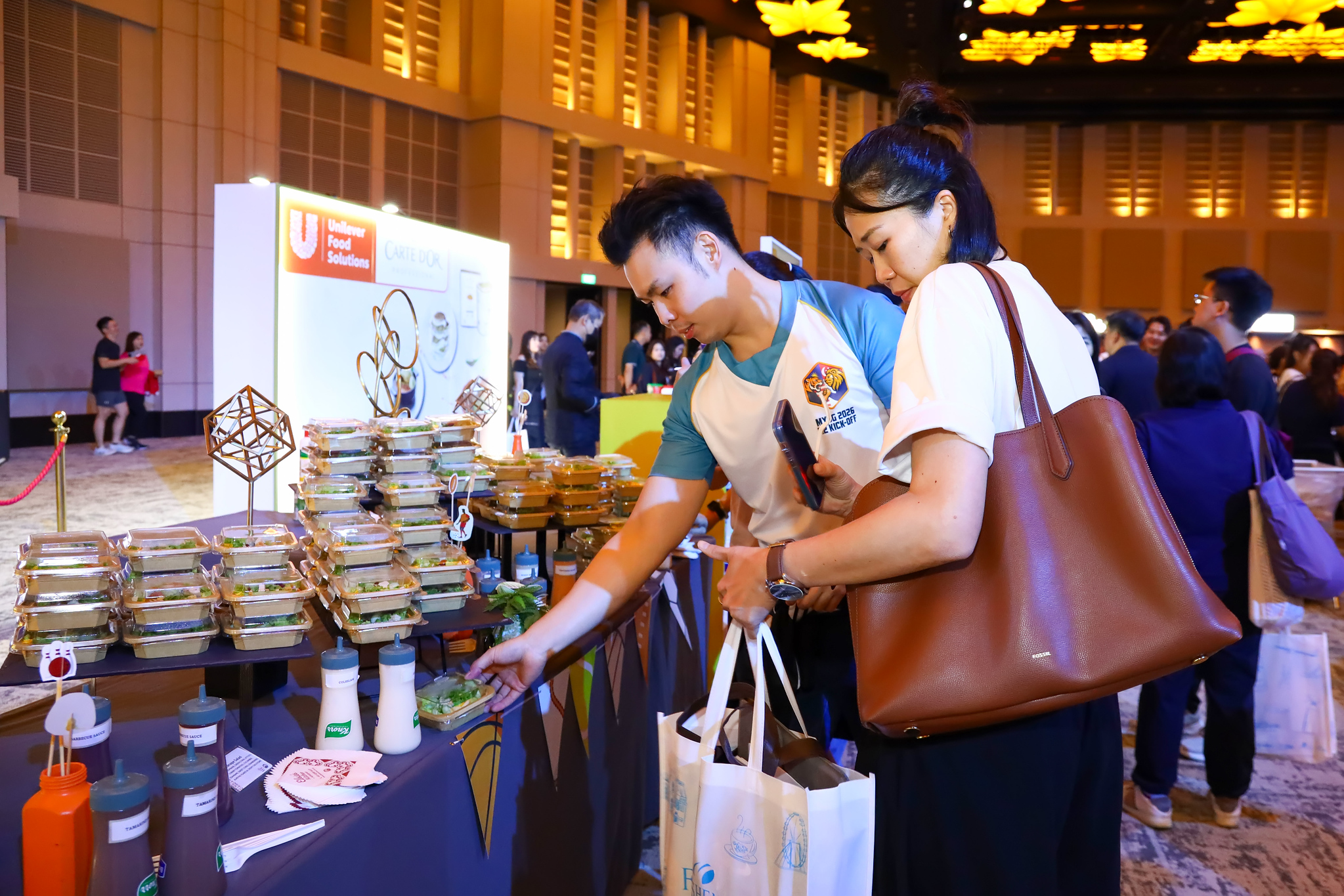 Guests sampling treats at a partner booth