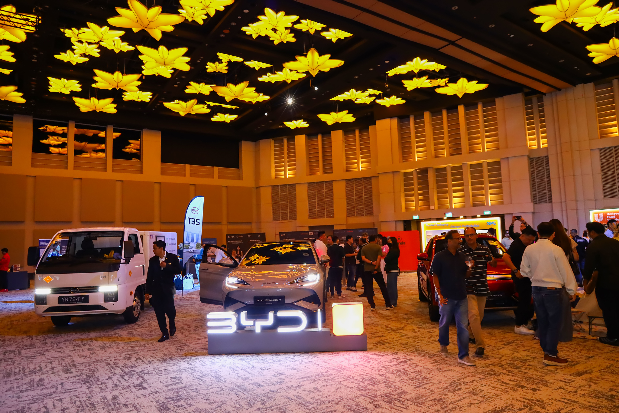 Guests exploring the partner showcase beside the BYD display