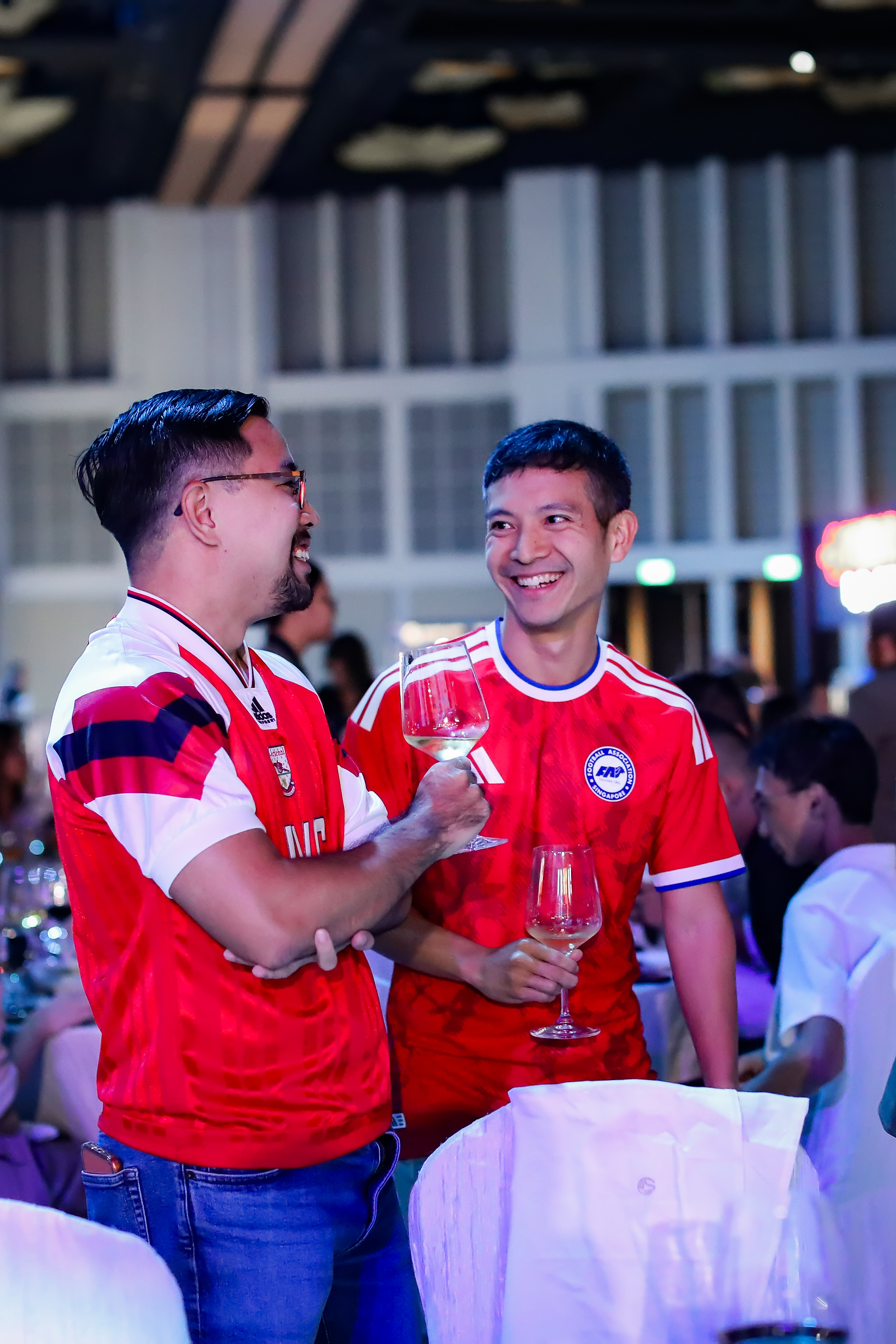Guests in football jerseys raise a glass
