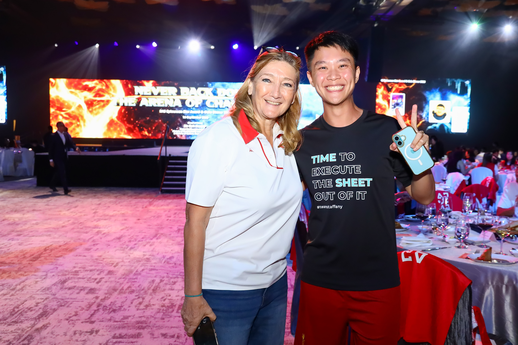 Guests pose in front of the stage
