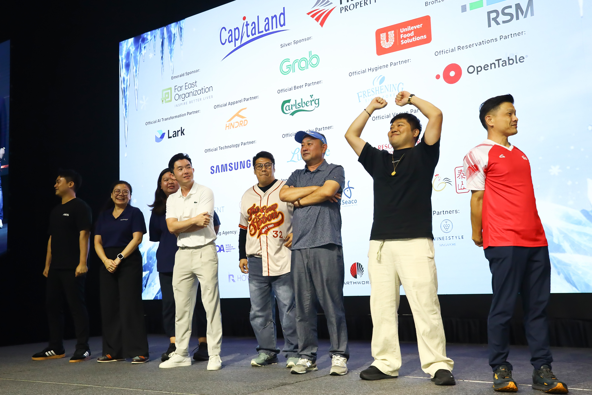 Sponsors and guests on stage in front of the partner wall