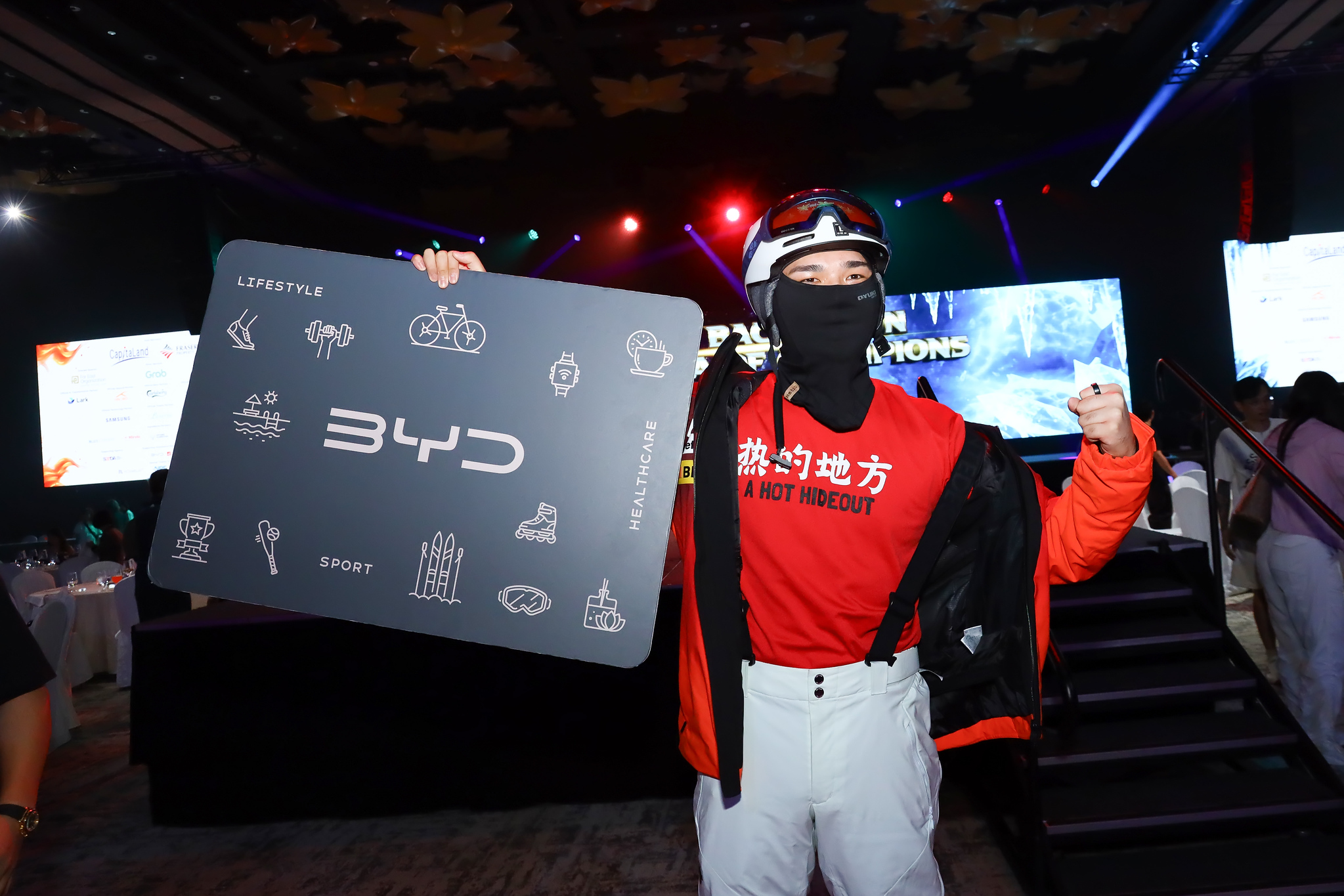 A lucky winner holds up the BYD prize
