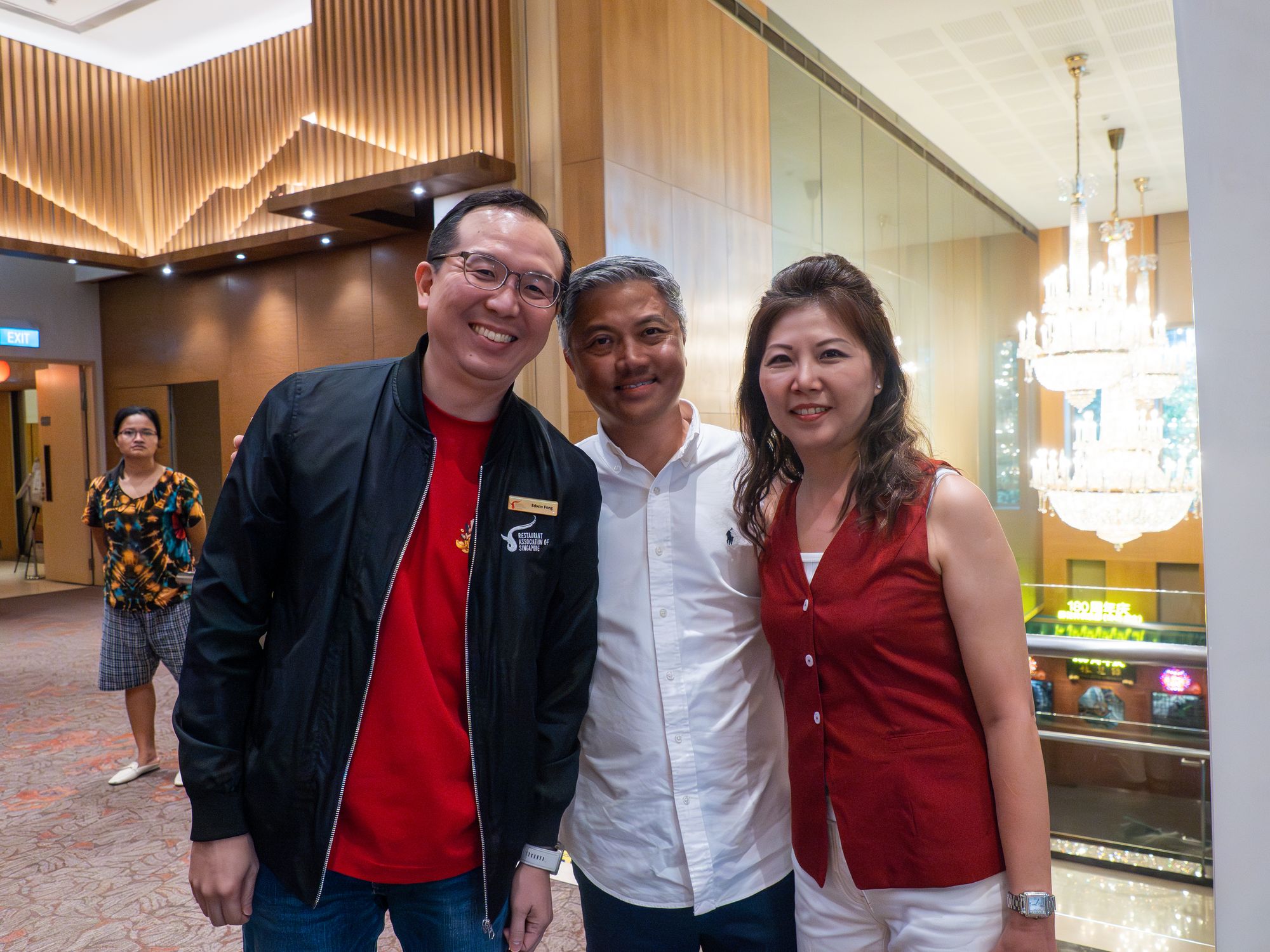Three guests pose for a photo at the reception