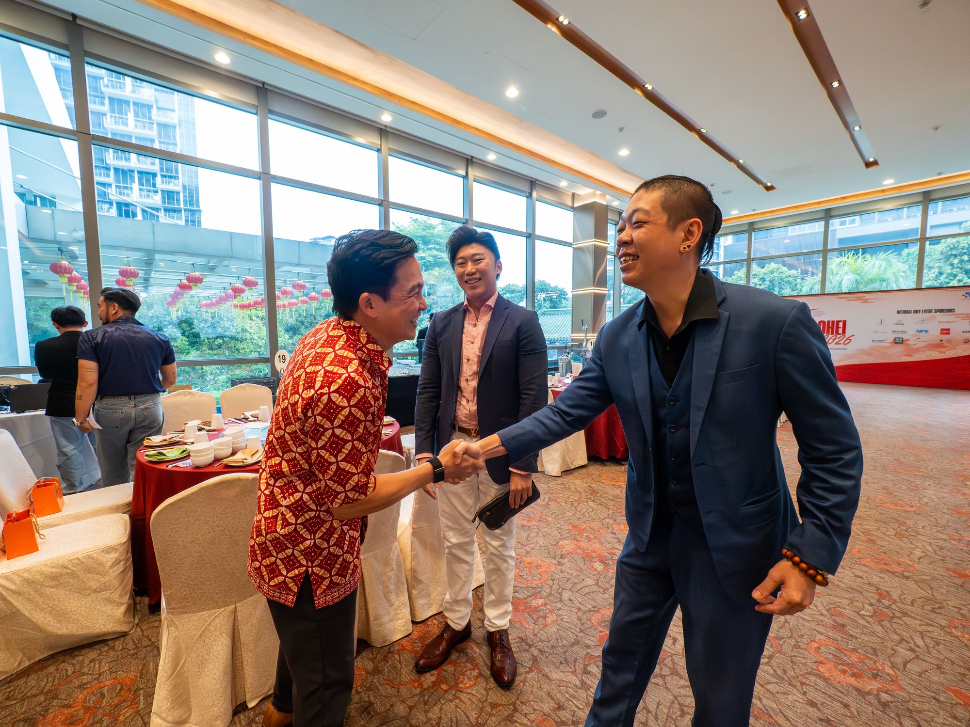 Members greet each other with a handshake in the ballroom at Chui Huay Lim Club