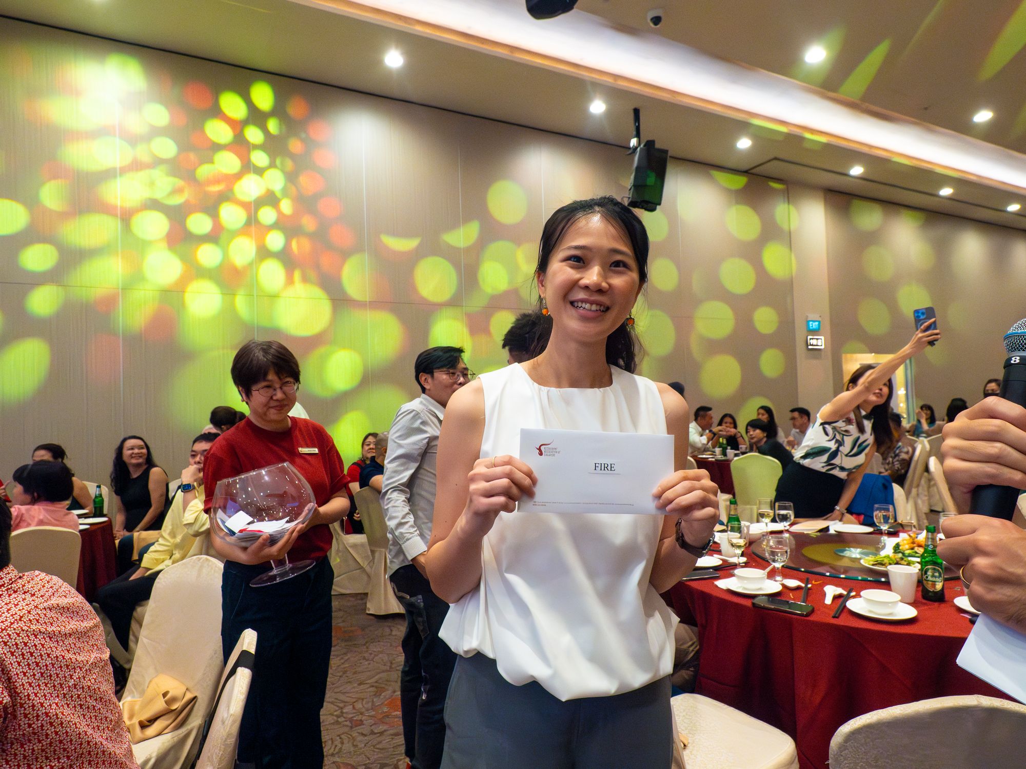 A lucky draw winner holds up her prize