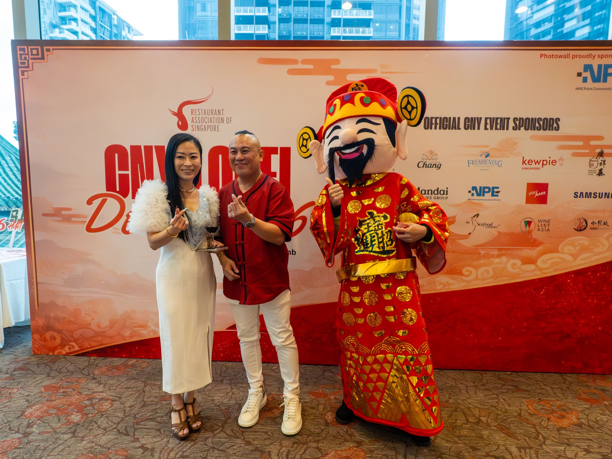 Guests with the God of Fortune at the CNY Lo Hei photo wall